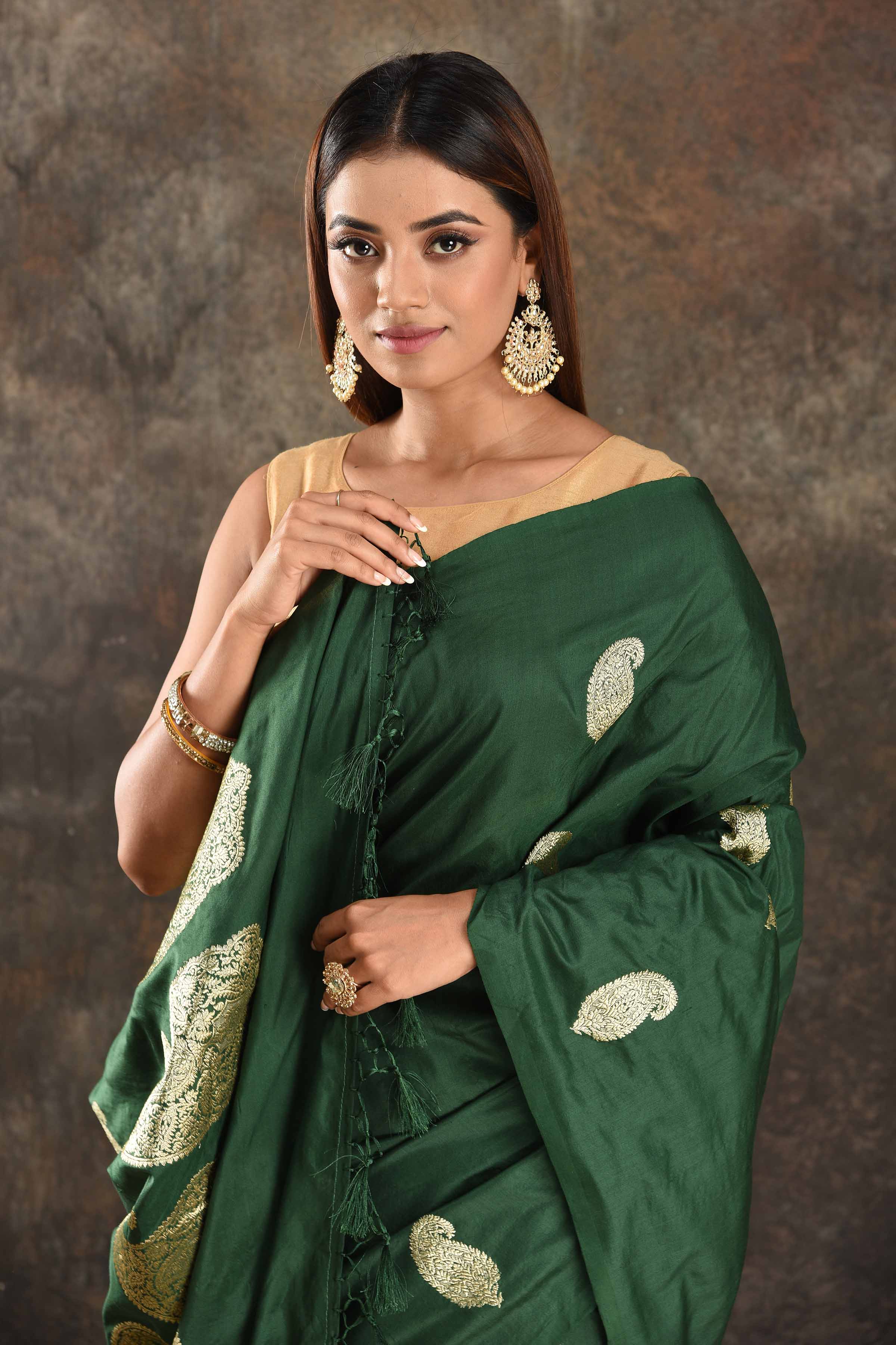 Buy stunning dark green silk saree online in USA with silver zari paisley buta. Be vision of elegance on special occasions in exquisite designer sarees, handwoven sarees, georgette sarees, embroidered sarees, Banarasi sarees from Pure Elegance Indian saree store in USA.-closeup