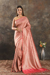 Buy peachish pink Banarasi silk saree online in USA with overall zari work. Be vision of elegance on special occasions in exquisite designer sarees, handwoven sarees, georgette sarees, embroidered sarees, Banarasi sarees from Pure Elegance Indian saree store in USA.-full view
