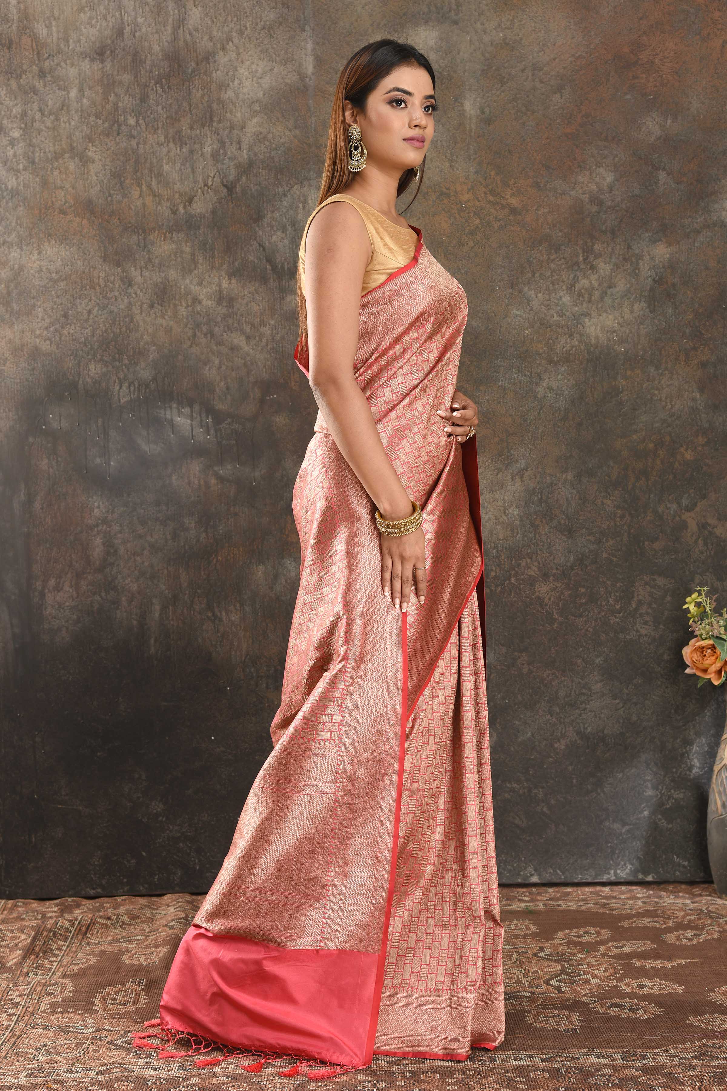 Buy peachish pink Banarasi silk saree online in USA with overall zari work. Be vision of elegance on special occasions in exquisite designer sarees, handwoven sarees, georgette sarees, embroidered sarees, Banarasi sarees from Pure Elegance Indian saree store in USA.-side