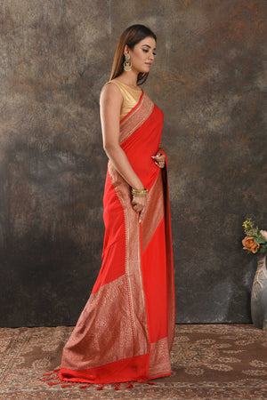 Shop stunning red crepe saree online in USA with zari border. Be vision of elegance on special occasions in exquisite designer sarees, handwoven sarees, georgette sarees, embroidered sarees, Banarasi sarees from Pure Elegance Indian saree store in USA.-side