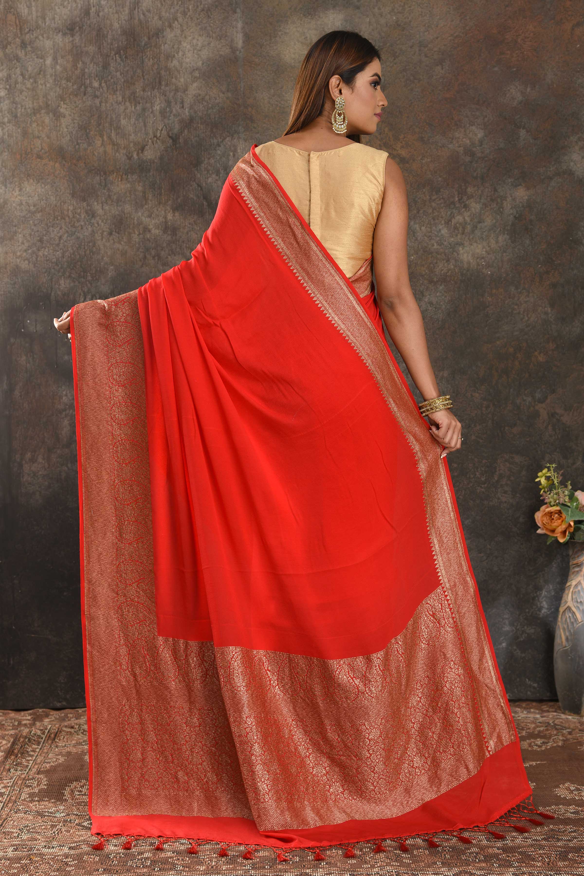Shop stunning red crepe saree online in USA with zari border. Be vision of elegance on special occasions in exquisite designer sarees, handwoven sarees, georgette sarees, embroidered sarees, Banarasi sarees from Pure Elegance Indian saree store in USA.-back
