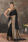 Buy stunning black crepe saree online in USA with zari border. Be vision of elegance on special occasions in exquisite designer sarees, handwoven sarees, georgette sarees, embroidered sarees, Banarasi sarees from Pure Elegance Indian saree store in USA.-full view
