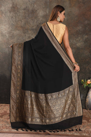 Buy stunning black crepe saree online in USA with zari border. Be vision of elegance on special occasions in exquisite designer sarees, handwoven sarees, georgette sarees, embroidered sarees, Banarasi sarees from Pure Elegance Indian saree store in USA.-back