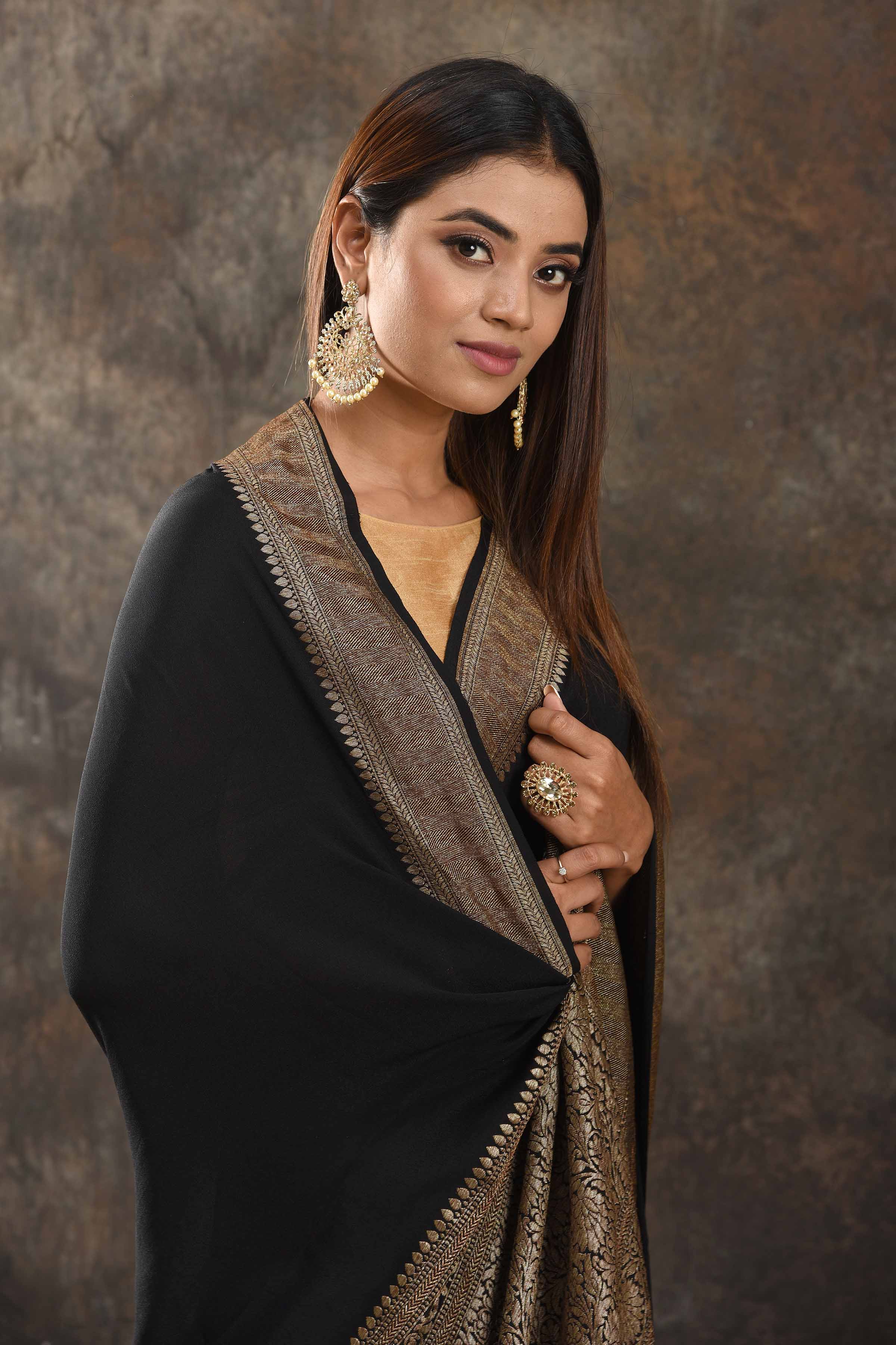 Buy stunning black crepe saree online in USA with zari border. Be vision of elegance on special occasions in exquisite designer sarees, handwoven sarees, georgette sarees, embroidered sarees, Banarasi sarees from Pure Elegance Indian saree store in USA.-closeup
