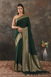 Shop beautiful bottle green crepe saree online in USA with antique zari border. Be vision of elegance on special occasions in exquisite designer sarees, handwoven sarees, georgette sarees, embroidered sarees, Banarasi sarees from Pure Elegance Indian saree store in USA.-full view