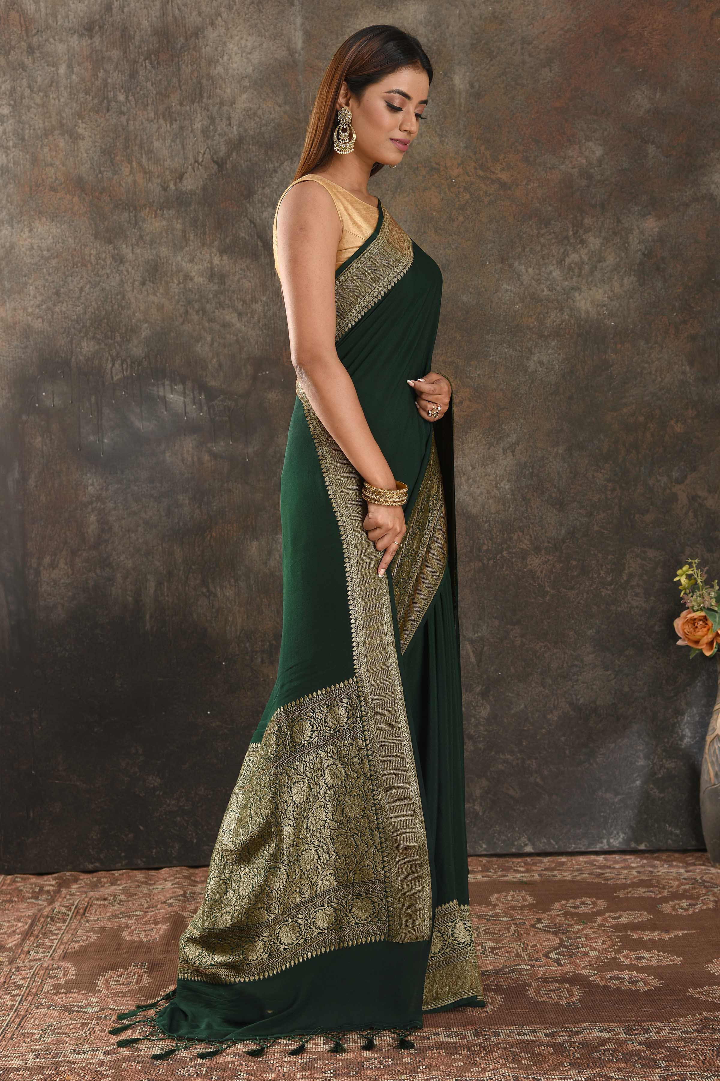 Shop beautiful bottle green crepe saree online in USA with antique zari border. Be vision of elegance on special occasions in exquisite designer sarees, handwoven sarees, georgette sarees, embroidered sarees, Banarasi sarees from Pure Elegance Indian saree store in USA.-side