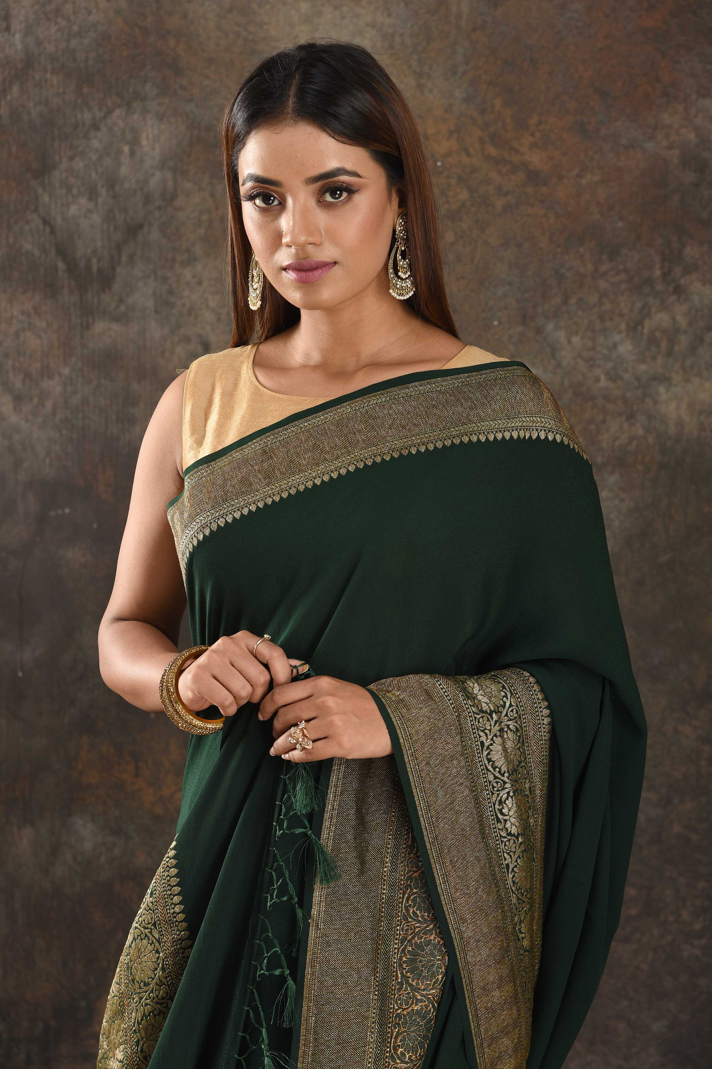Shop beautiful bottle green crepe saree online in USA with antique zari border. Be vision of elegance on special occasions in exquisite designer sarees, handwoven sarees, georgette sarees, embroidered sarees, Banarasi sarees from Pure Elegance Indian saree store in USA.-closeup