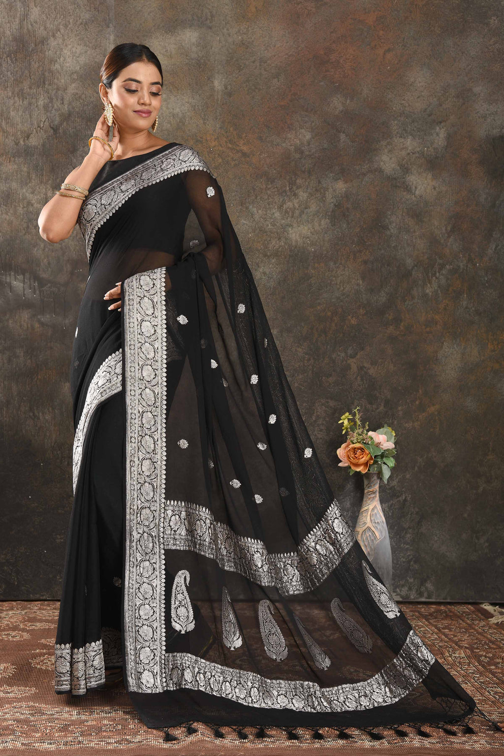 Shop black georgette Banarasi saree online in USA with silver zari border. Be vision of elegance on special occasions in exquisite designer sarees, handwoven sarees, georgette sarees, embroidered sarees, Banarasi saree, pure silk saris from Pure Elegance Indian saree store in USA.-full view