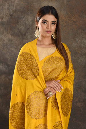 Buy yellow Muga Banarasi sari online in USA with antique zari motifs. Be vision of elegance on special occasions in exquisite designer sarees, handwoven sarees, georgette sarees, embroidered sarees, Banarasi saree, pure silk saris from Pure Elegance Indian saree store in USA.-closeup