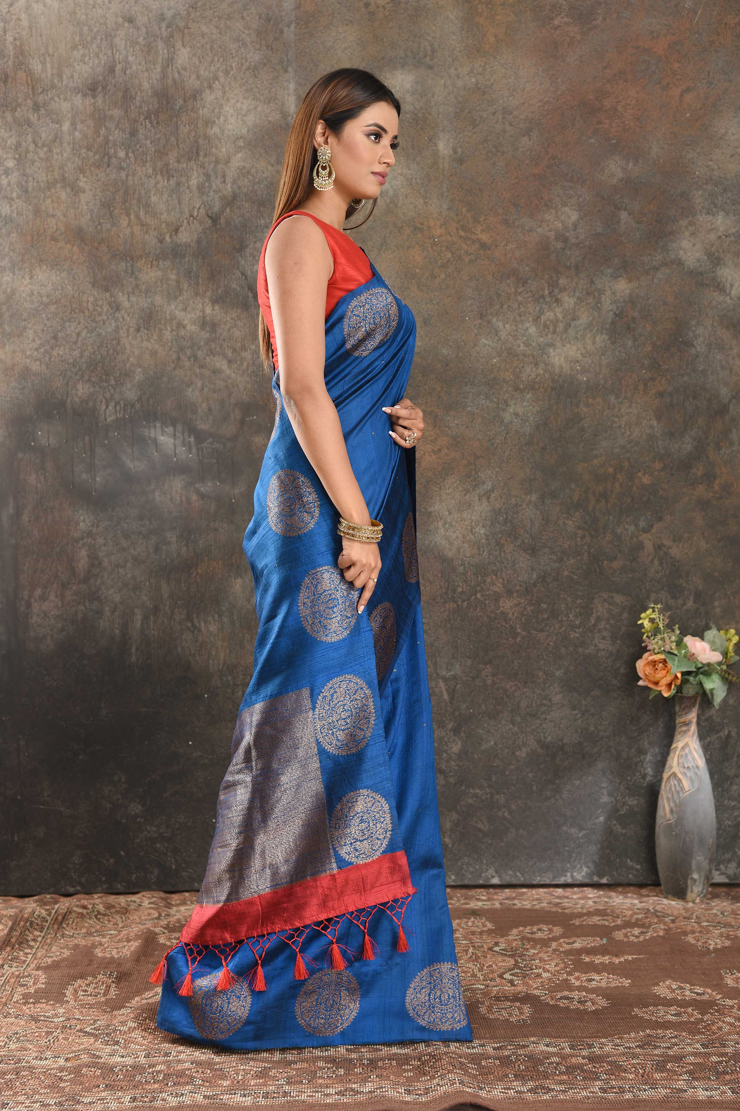 Shop beautiful royal blue tussar Banarasi sari online in USA with zari buta. Be vision of elegance on special occasions in exquisite designer sarees, handwoven sarees, georgette sarees, embroidered sarees, Banarasi saree, pure silk saris from Pure Elegance Indian saree store in USA.-side