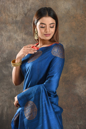 Shop beautiful royal blue tussar Banarasi sari online in USA with zari buta. Be vision of elegance on special occasions in exquisite designer sarees, handwoven sarees, georgette sarees, embroidered sarees, Banarasi saree, pure silk saris from Pure Elegance Indian saree store in USA.-closeup