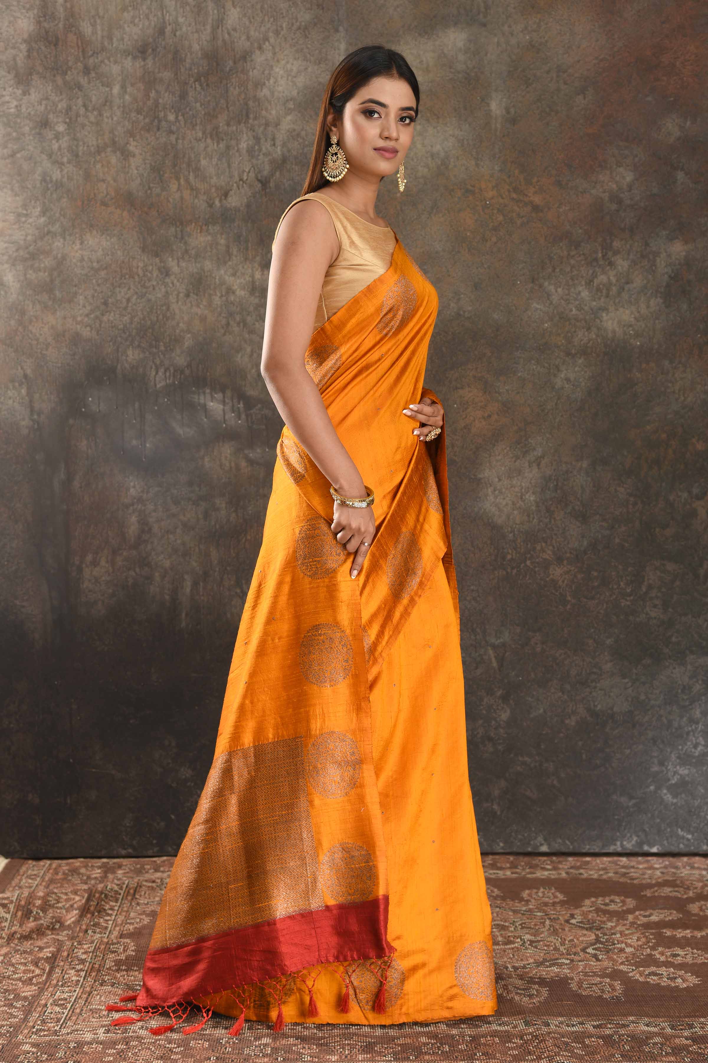 Shop beautiful mango yellow tussar Banarasi sari online in USA with antique zari buta. Be vision of elegance on special occasions in exquisite designer sarees, handwoven sarees, georgette sarees, embroidered sarees, Banarasi saree, pure silk saris from Pure Elegance Indian saree store in USA.-side