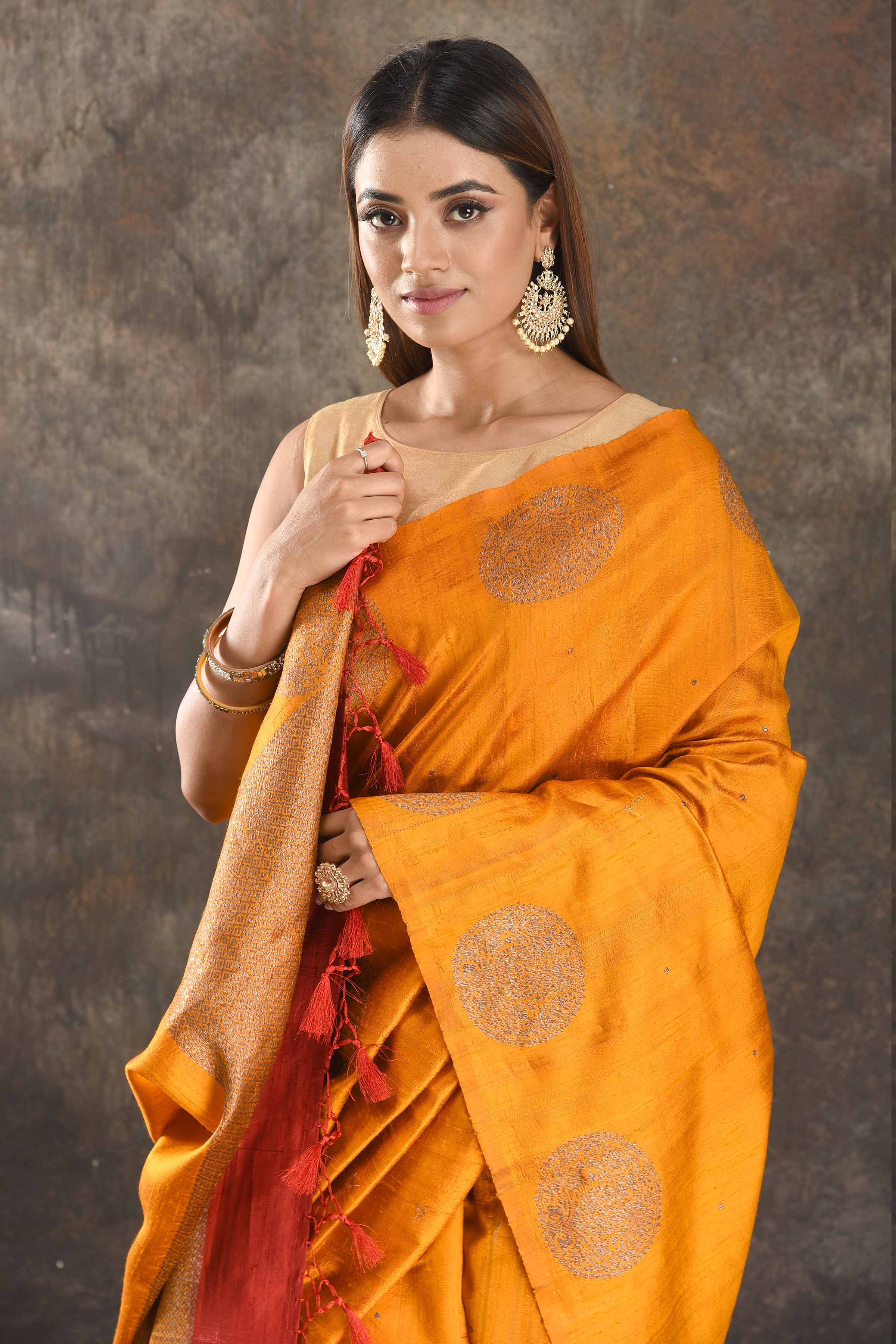 Shop beautiful mango yellow tussar Banarasi sari online in USA with antique zari buta. Be vision of elegance on special occasions in exquisite designer sarees, handwoven sarees, georgette sarees, embroidered sarees, Banarasi saree, pure silk saris from Pure Elegance Indian saree store in USA.-closeup