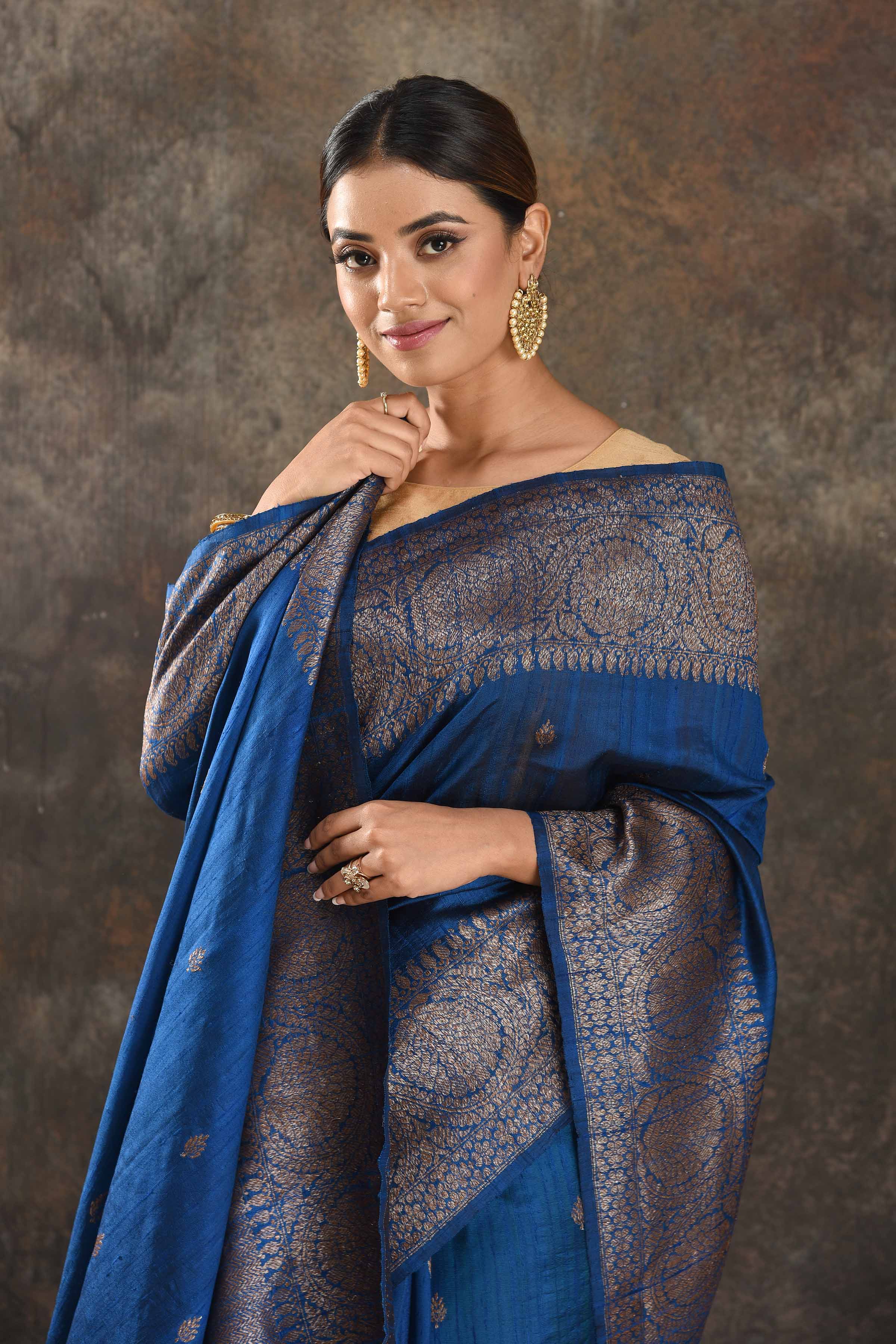 Shop stunning blue tussar Banarasi sari online in USA with antique zari border. Be vision of elegance on special occasions in exquisite designer sarees, handwoven sarees, georgette sarees, embroidered sarees, Banarasi saree, pure silk saris from Pure Elegance Indian saree store in USA.-closeup