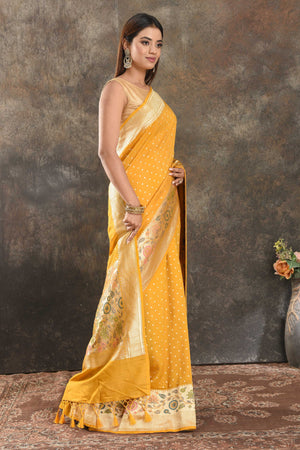 Buy beautiful mango yellow tussar Banarasi sari online in USA with floral zari border. Be vision of elegance on special occasions in exquisite designer sarees, handwoven sarees, georgette sarees, embroidered sarees, Banarasi saree, pure silk saris, tussar sarees from Pure Elegance Indian saree store in USA.-side