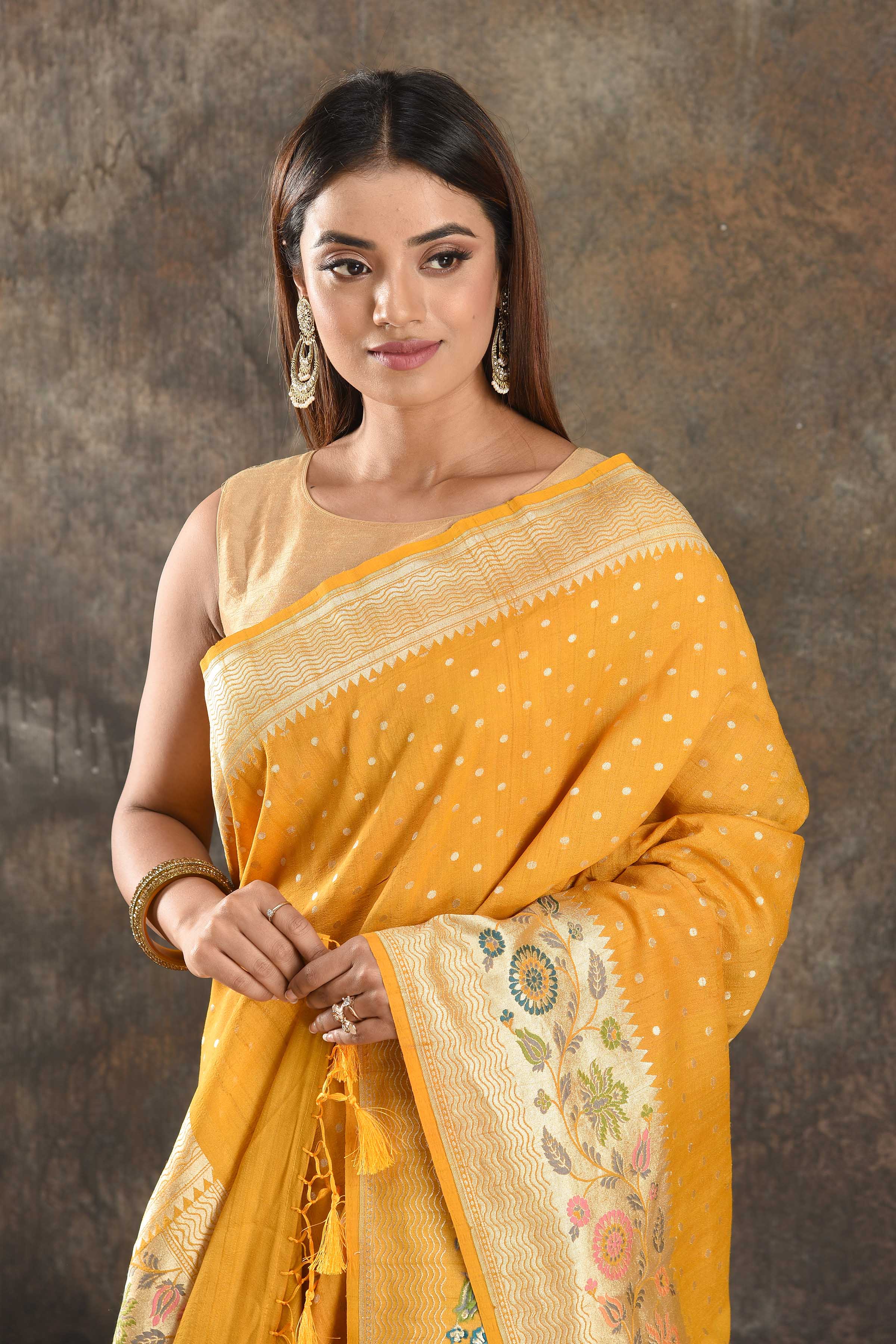 Buy beautiful mango yellow tussar Banarasi sari online in USA with floral zari border. Be vision of elegance on special occasions in exquisite designer sarees, handwoven sarees, georgette sarees, embroidered sarees, Banarasi saree, pure silk saris, tussar sarees from Pure Elegance Indian saree store in USA.-closeup