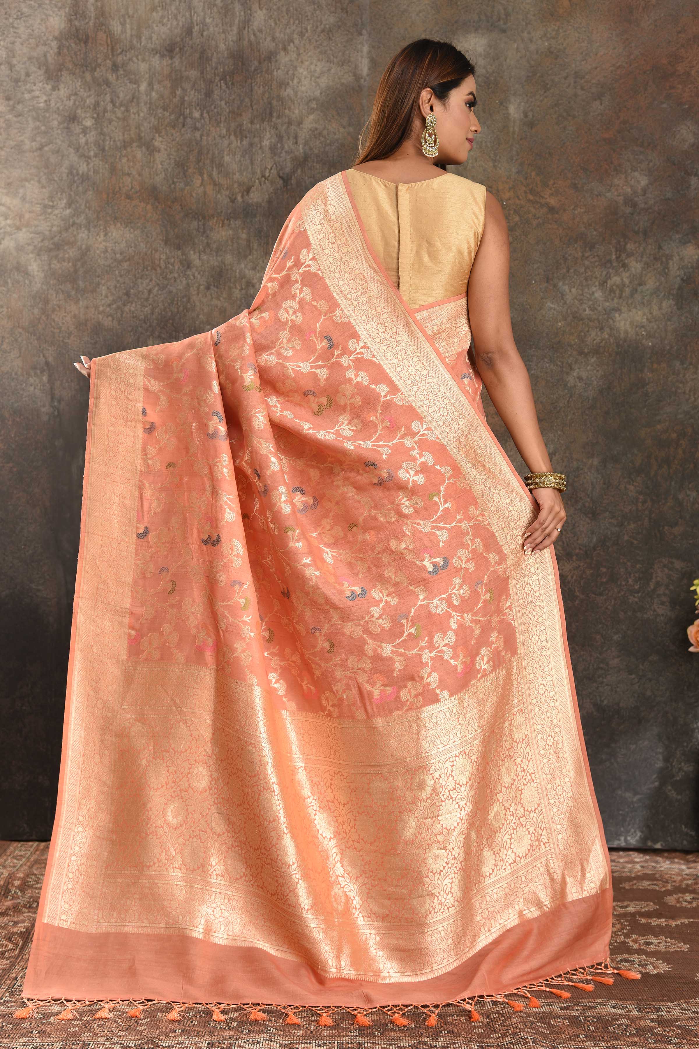 Buy beautiful peach tussar Banarasi saree online in USA with floral zari jaal. Be vision of elegance on special occasions in exquisite designer sarees, handwoven sarees, georgette sarees, embroidered sarees, Banarasi saree, pure silk saris, tussar sarees from Pure Elegance Indian saree store in USA.-back