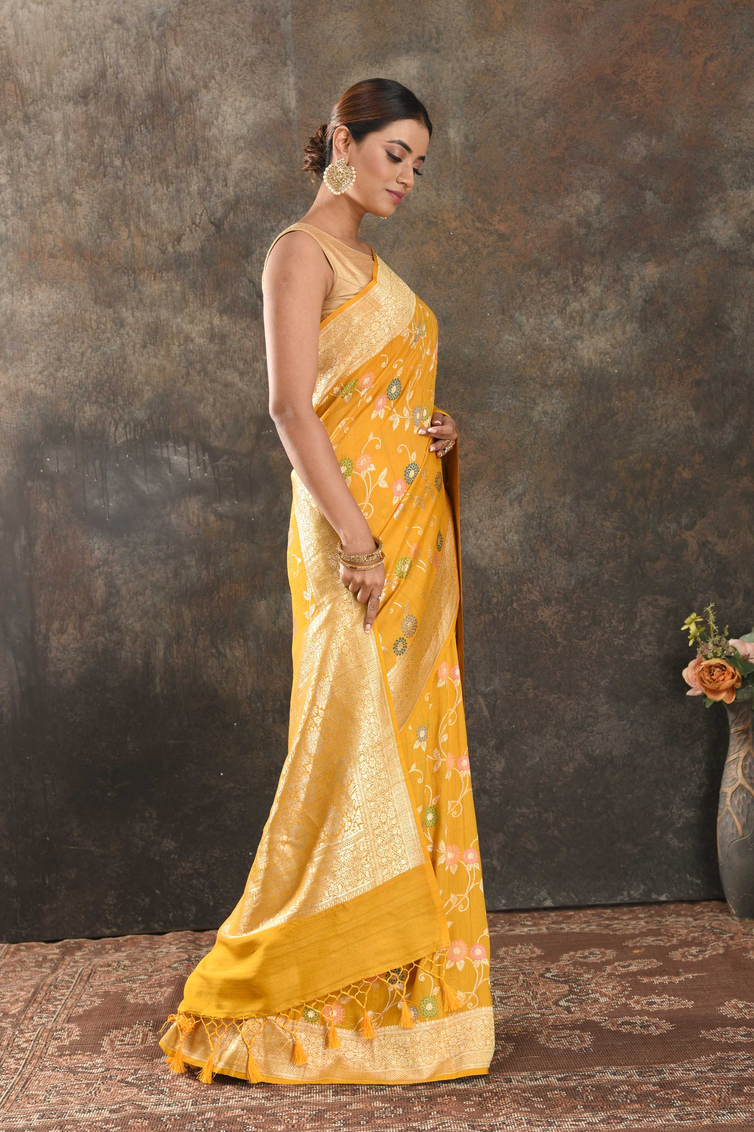 Buy beautiful mango yellow tussar Banarasi sari online in USA with floral zari minakari jaal. Be vision of elegance on special occasions in exquisite designer sarees, handwoven sarees, georgette sarees, embroidered sarees, Banarasi saree, pure silk saris, tussar sarees from Pure Elegance Indian saree store in USA.-side
