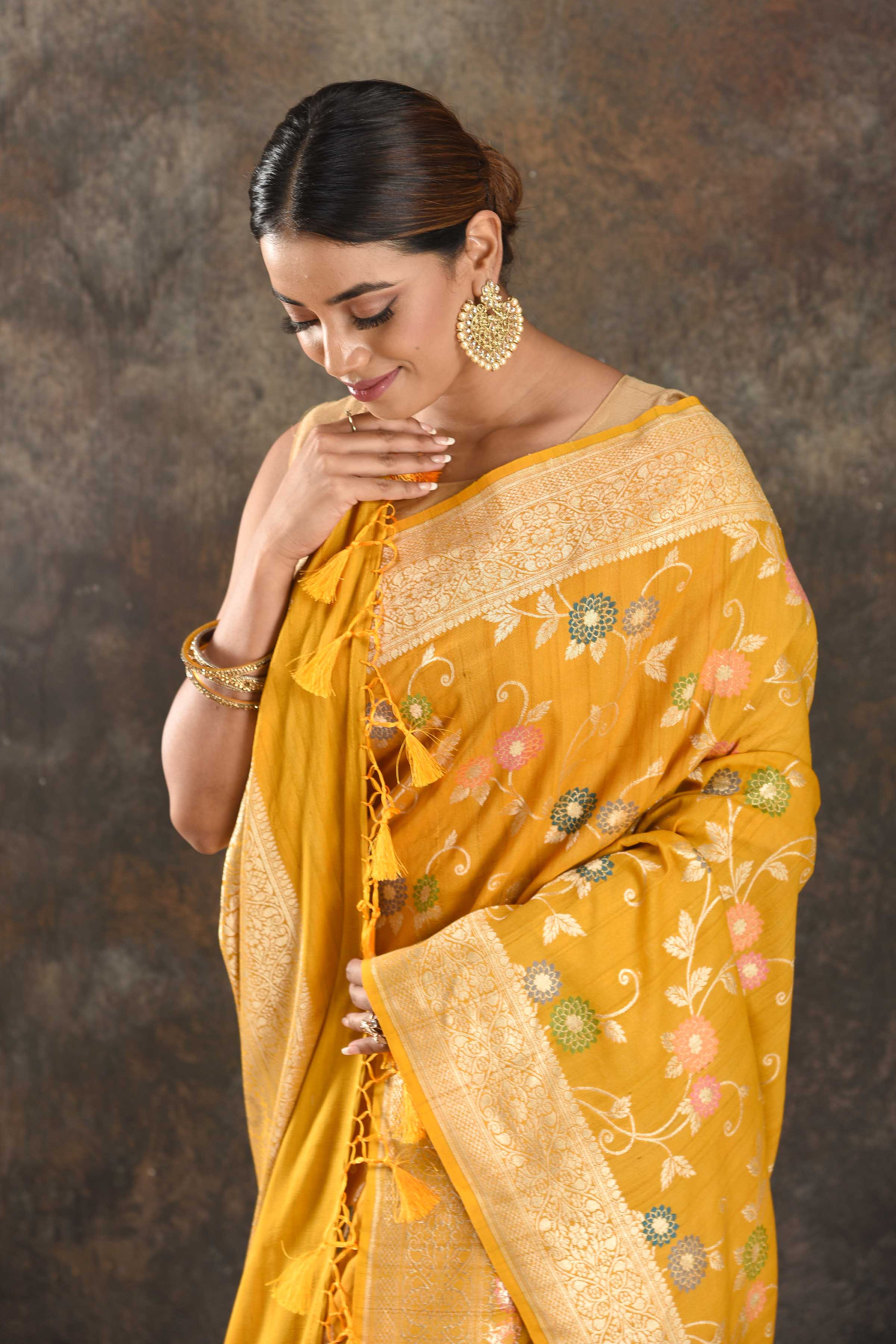 Buy beautiful mango yellow tussar Banarasi sari online in USA with floral zari minakari jaal. Be vision of elegance on special occasions in exquisite designer sarees, handwoven sarees, georgette sarees, embroidered sarees, Banarasi saree, pure silk saris, tussar sarees from Pure Elegance Indian saree store in USA.-closeup