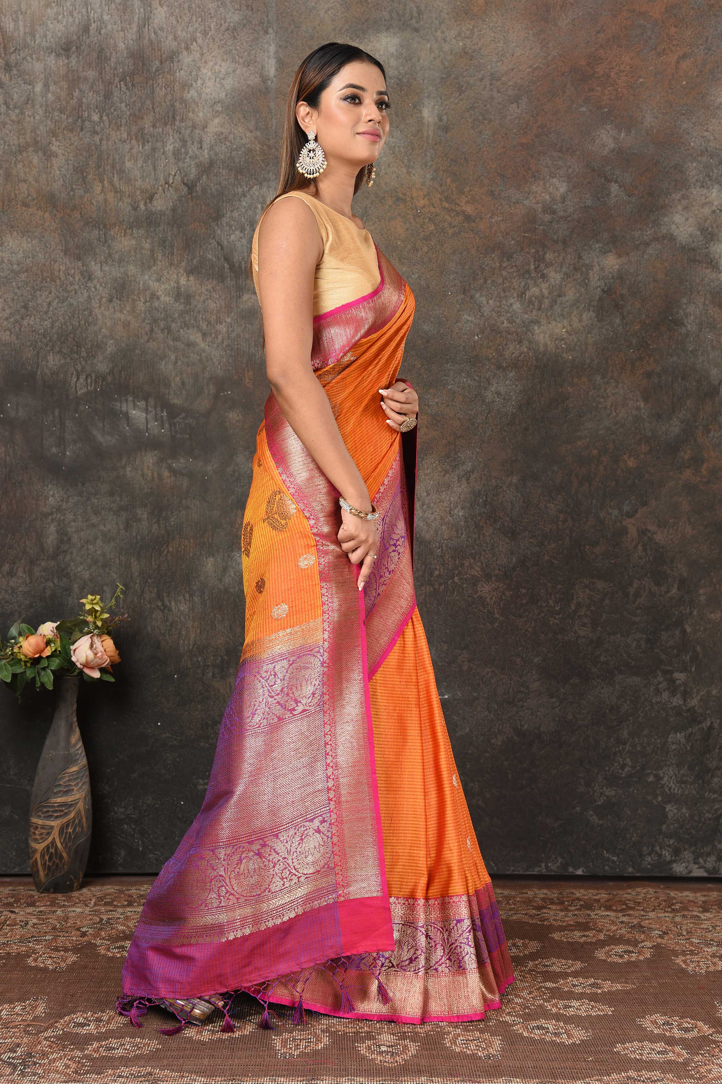 Buy beautiful orange Banarasi sari online in USA with pink purple zari border. Look royal at weddings and festive occasions in exquisite Banarasi sarees, handwoven sarees, tussar silk sarees, Bollywood sarees, partywear sarees from Pure Elegance Indian saree store in USA.-side