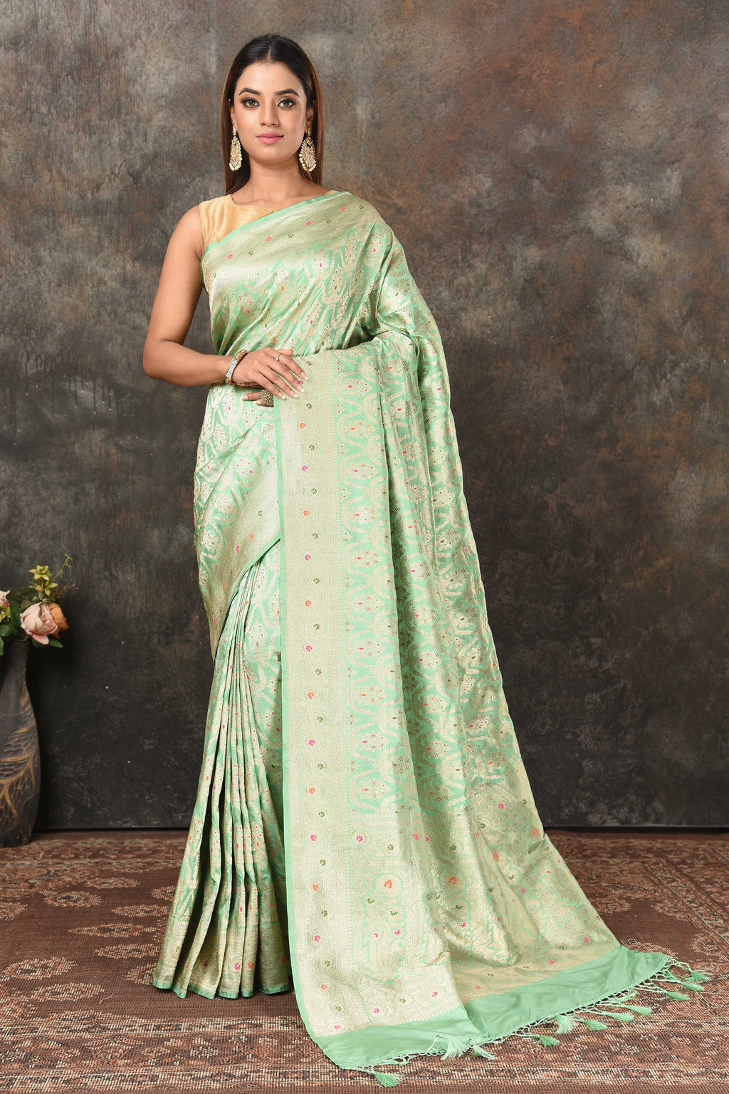 Buy pastel green Banarsi sari online in USA with zari minakari jaal. Look royal at weddings and festive occasions in exquisite Banarasi saris, handwoven sarees, tussar silk sarees, Bollywood sarees, partywear sarees from Pure Elegance Indian saree store in USA.-full view
