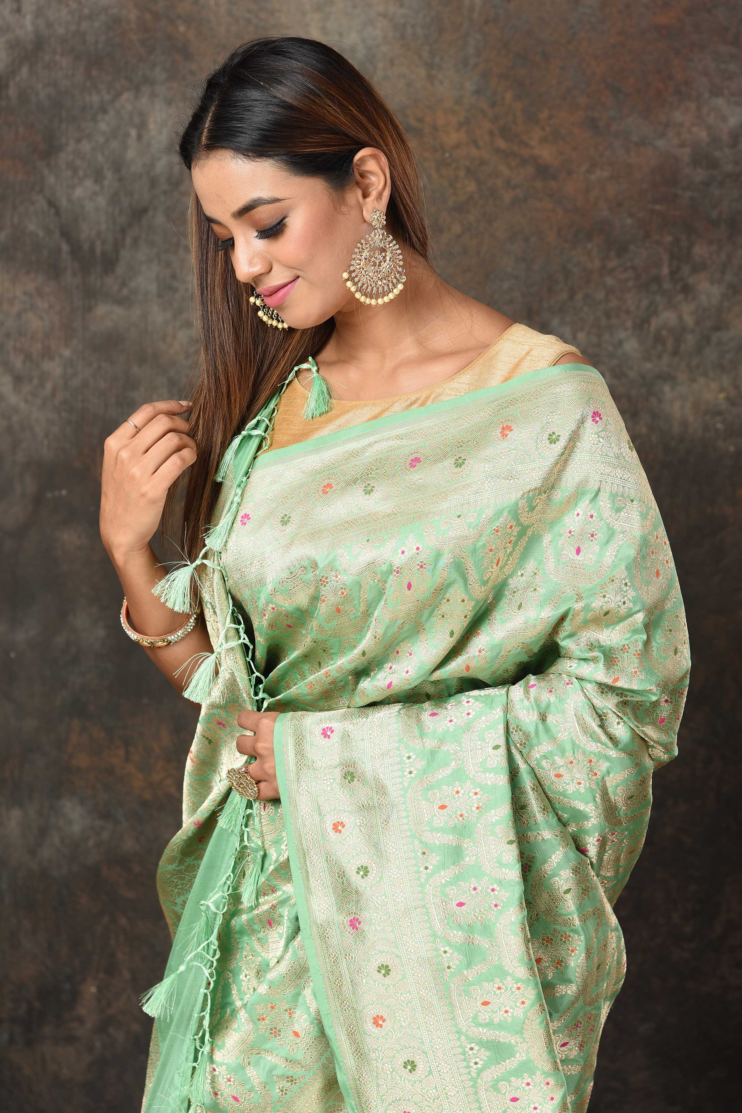 Buy pastel green Banarsi sari online in USA with zari minakari jaal. Look royal at weddings and festive occasions in exquisite Banarasi saris, handwoven sarees, tussar silk sarees, Bollywood sarees, partywear sarees from Pure Elegance Indian saree store in USA.-closeup
