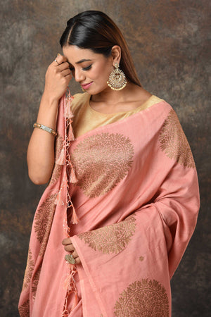 Shop blush pink Benarasi sari online in USA with antique zari motifs. Look royal at weddings and festive occasions in exquisite Banarasi saris, handwoven sarees, tussar silk sarees, Bollywood sarees, partywear sarees from Pure Elegance Indian saree store in USA.-closeup