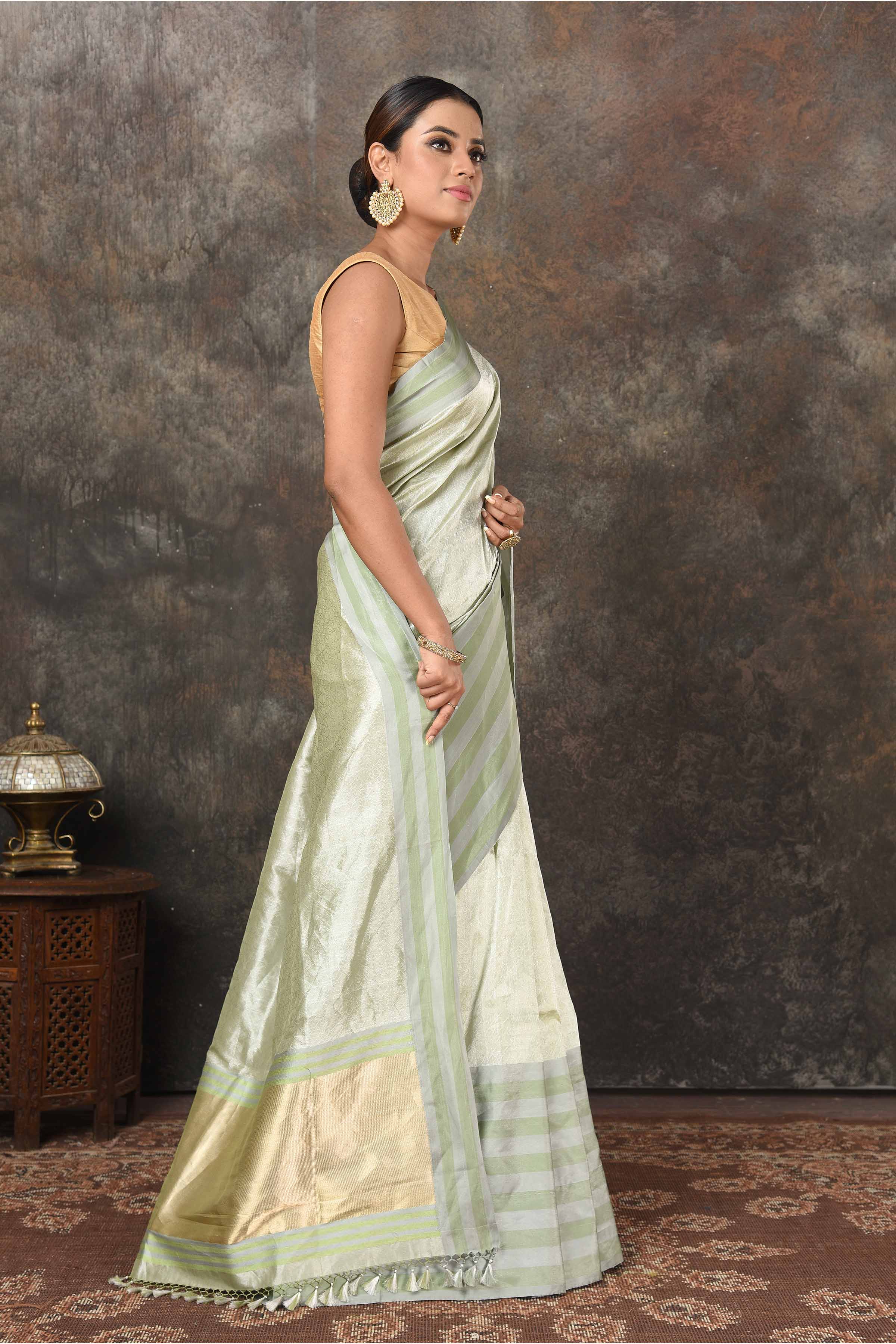 Buy beautiful pista green Banarasi silk sari online in USA with stripes border. Radiate elegance on special occasions in exquisite designer sarees, handwoven sarees, georgette sarees, embroidered sarees, Banarasi saree, pure silk saris, tussar sarees from Pure Elegance Indian saree store in USA.-side