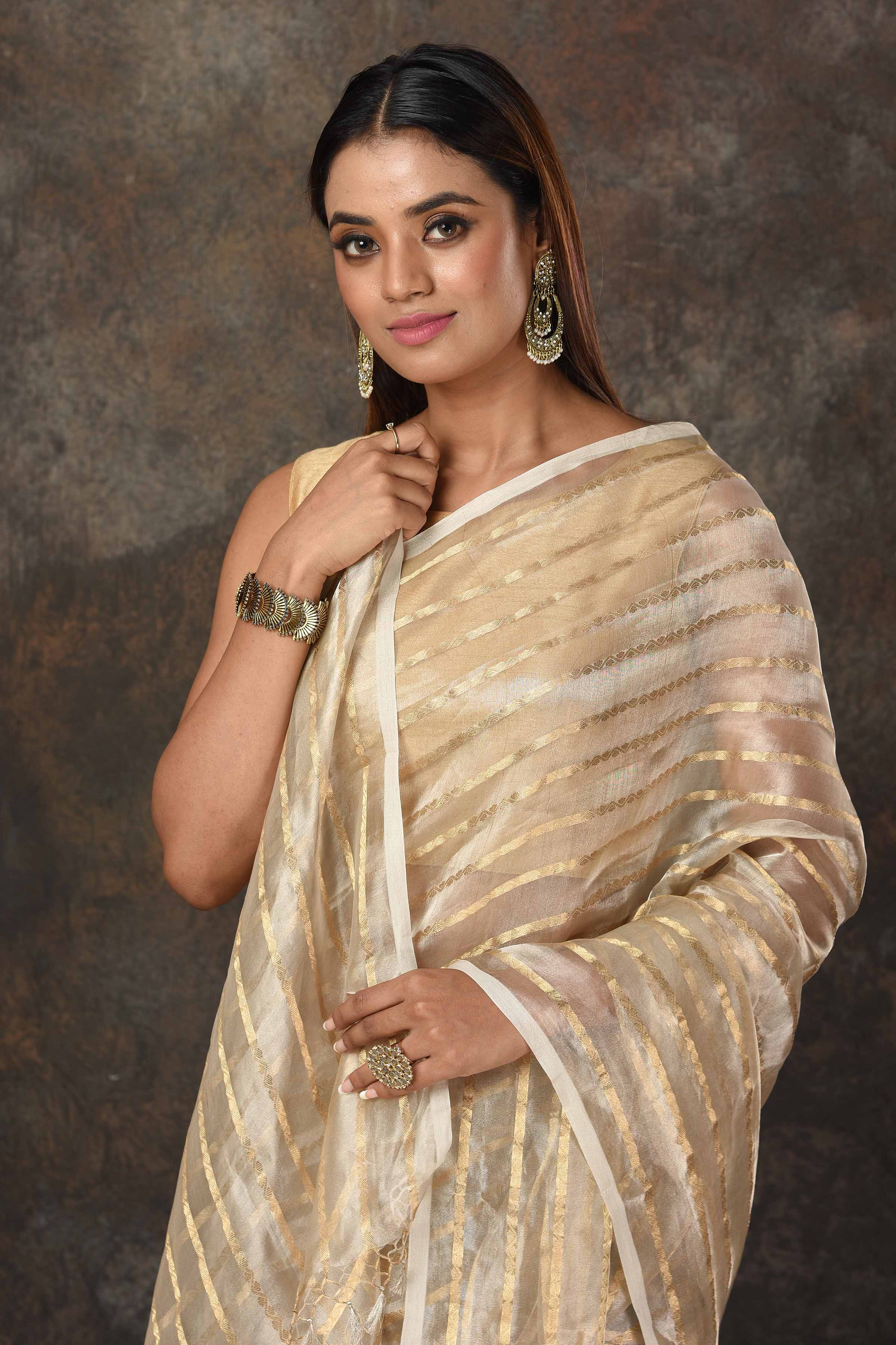 Shop stunning golden striped tissue Banarasi sari online in USA. Radiate elegance on special occasions in exquisite designer sarees, handwoven sarees, georgette sarees, embroidered sarees, Banarasi saree, pure silk saris, tussar sarees from Pure Elegance Indian saree store in USA.-closeup
