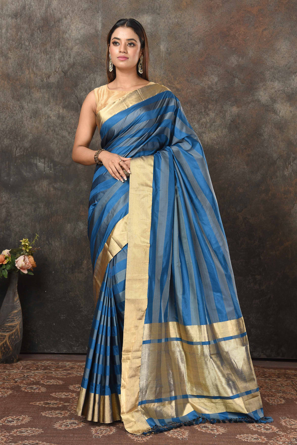 Shop stunning blue grey stripes Banarasi Mashru silk saree online in USA with golden border. Radiate elegance on special occasions in exquisite designer sarees, handwoven sarees, georgette sarees, embroidered sarees, Banarasi saree, pure silk saris, tussar sarees from Pure Elegance Indian saree store in USA.-full view