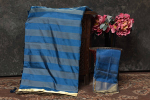 Shop stunning blue grey stripes Banarasi Mashru silk saree online in USA with golden border. Radiate elegance on special occasions in exquisite designer sarees, handwoven sarees, georgette sarees, embroidered sarees, Banarasi saree, pure silk saris, tussar sarees from Pure Elegance Indian saree store in USA.-blouse