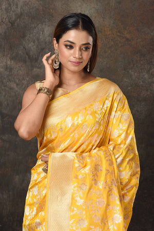 Buy stunning yellow Banarasi Mashru silk sari online in USA with golden zari jaal. Radiate elegance on special occasions in exquisite designer sarees, handwoven sarees, georgette sarees, embroidered sarees, Banarasi saree, pure silk saris, tussar sarees from Pure Elegance Indian saree store in USA.-closeup