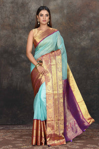 Buy beautiful light blue Banarasi stripes Kanjeevaram saree online in USA with golden zari border. Be the center of attraction on special occasions in ethnic sarees, designer sarees, embroidered sarees, handwoven sarees, pure silk sarees from Pure Elegance Indian saree store in USA.-full view