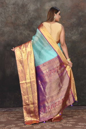 Buy beautiful light blue Banarasi stripes Kanjeevaram saree online in USA with golden zari border. Be the center of attraction on special occasions in ethnic sarees, designer sarees, embroidered sarees, handwoven sarees, pure silk sarees from Pure Elegance Indian saree store in USA.-back