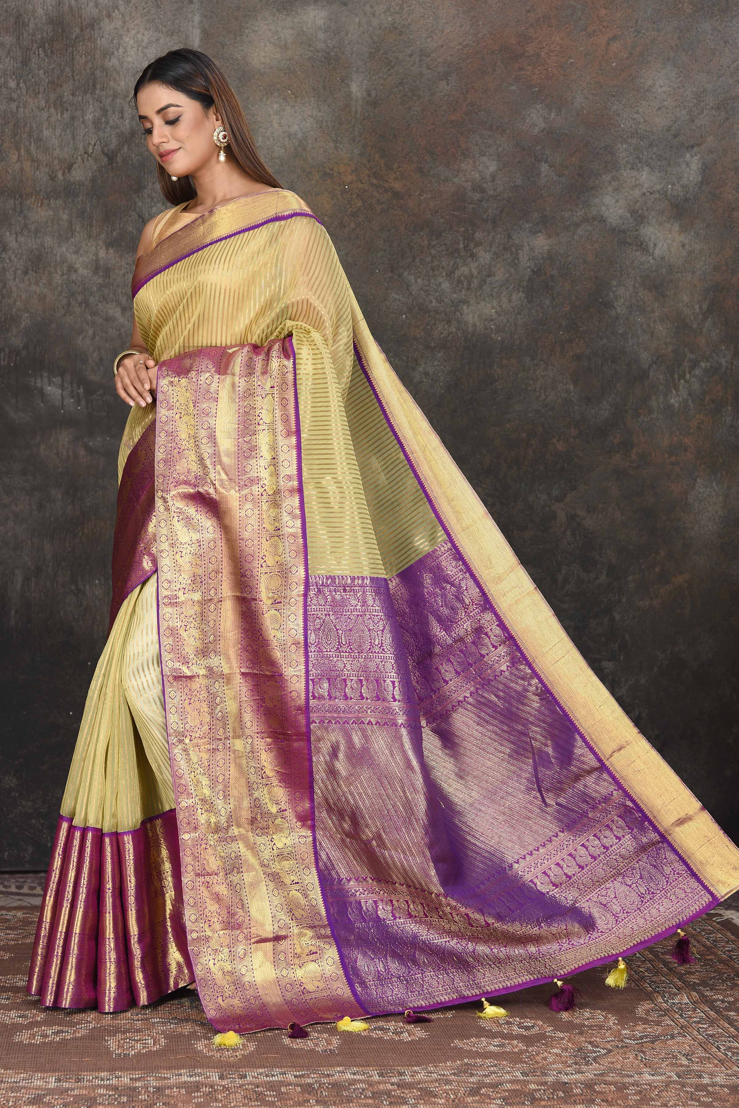 Buy beautiful yellow Kanjeevaram Kora striped saree online in USA with purple zari border. Be the center of attraction on special occasions in ethnic sarees, designer sarees, embroidered sarees, handwoven sarees, pure silk sarees from Pure Elegance Indian saree store in USA.-pallu