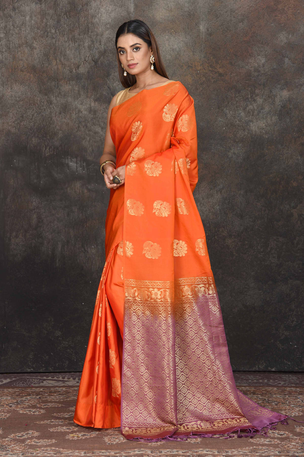 Buy stunning orange Kanjivaram soft silk sari online in USA with purple zari border. Be the center of attraction on special occasions in ethnic sarees, designer sarees, embroidered sarees, handwoven sarees, pure silk sarees from Pure Elegance Indian saree store in USA.-full view