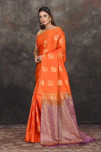 Buy stunning orange Kanjivaram soft silk sari online in USA with purple zari border. Be the center of attraction on special occasions in ethnic sarees, designer sarees, embroidered sarees, handwoven sarees, pure silk sarees from Pure Elegance Indian saree store in USA.-full view