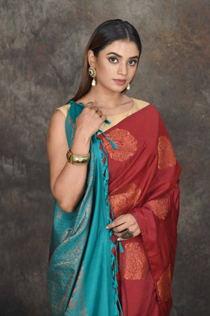Shop beautiful maroon Kanjivaram soft silk sari online in USA with sea green zari pallu. Be the center of attraction on special occasions in ethnic sarees, designer sarees, embroidered sarees, handwoven sarees, pure silk sarees from Pure Elegance Indian saree store in USA.-closeup