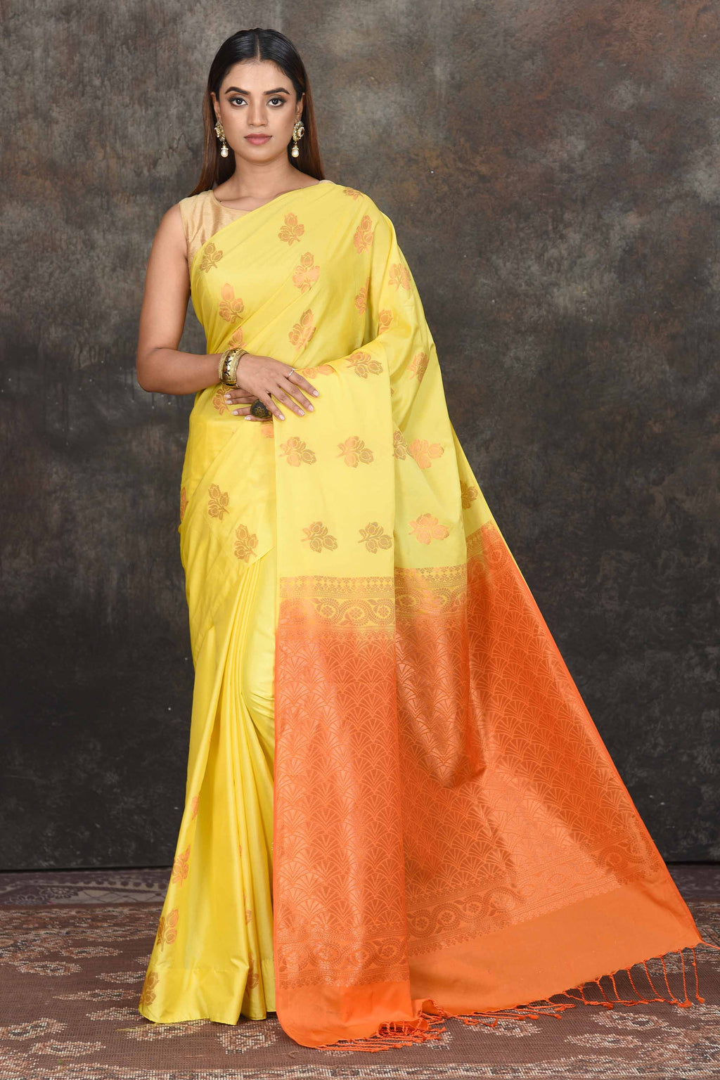 Buy beautiful light yellow Kanjivaram soft silk saree online in USA with orange zari pallu. Be the center of attraction on special occasions in ethnic sarees, designer sarees, embroidered sarees, handwoven sarees, pure silk sarees from Pure Elegance Indian saree store in USA.-full view