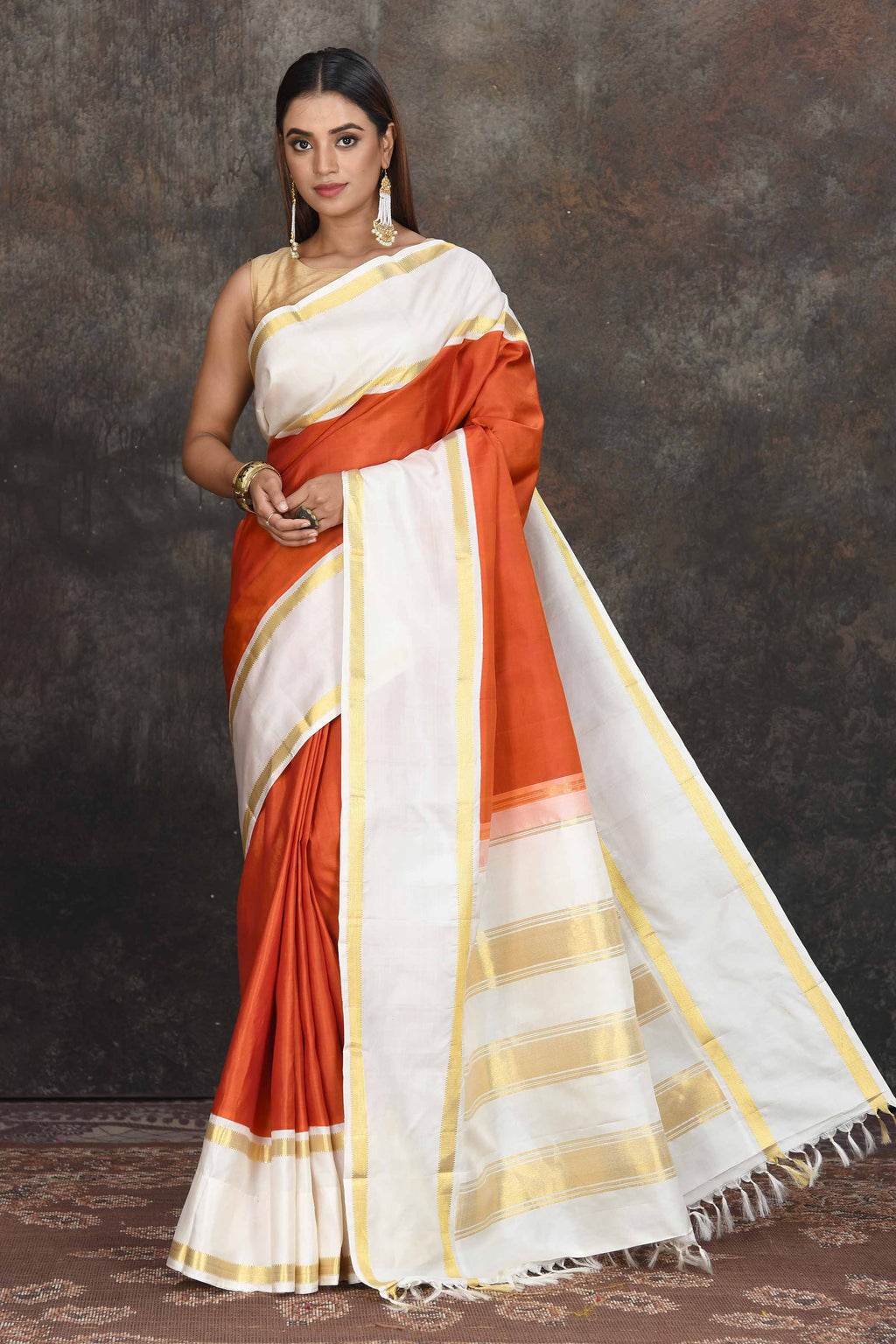 Buy beautiful rust orange Kanjeevaram sari online in USA with cream border. Go for a rich traditional look on weddings and festive occasions in pure silk sarees, Kanchipuram silk sarees, handloom sarees, Banarasi sarees from Pure Elegance Indian fashion store in USA.-full view
