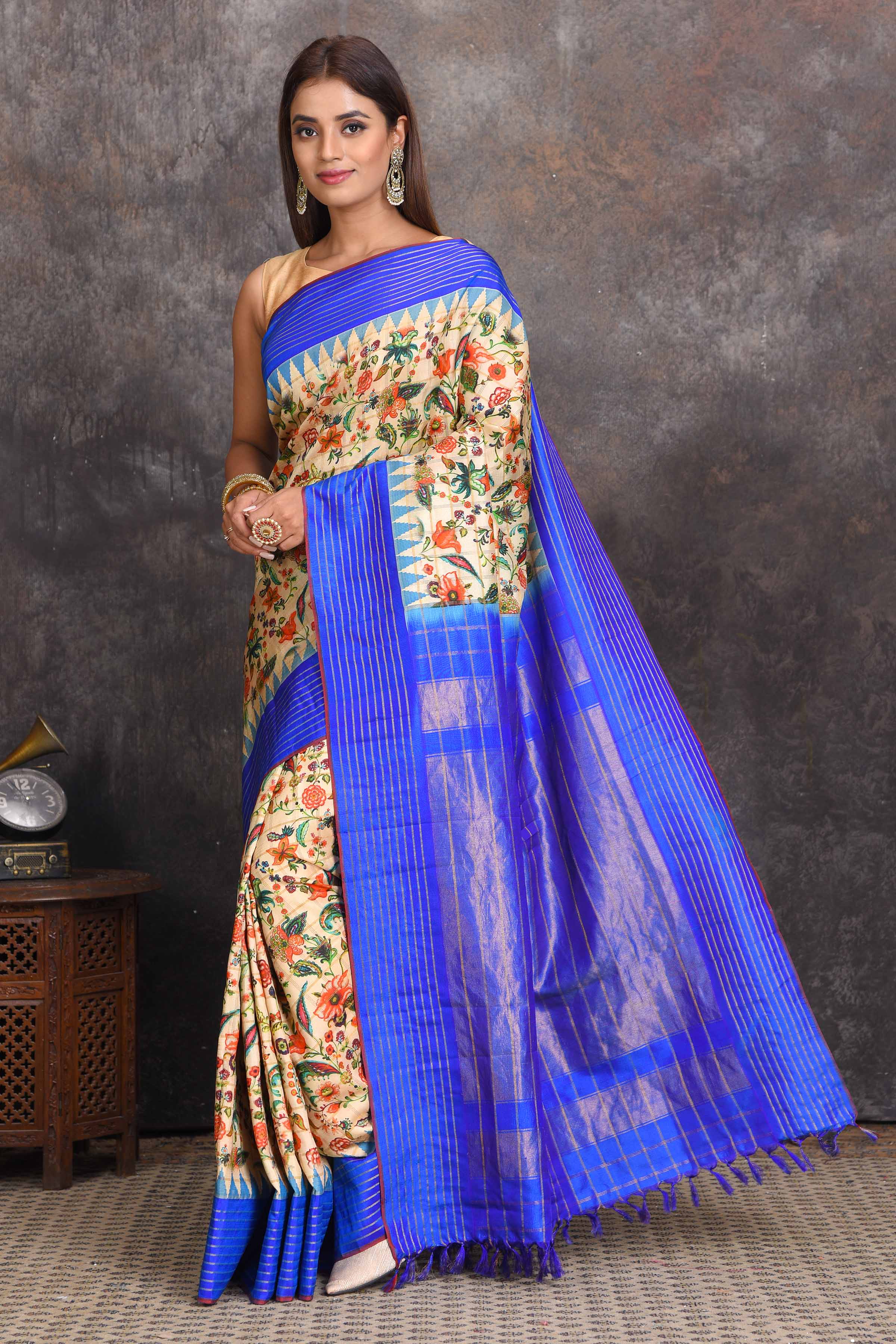 Shop cream printed Gadhwal silk saree online in USA with blue border. Get festive ready in beautiful Kanchipuram silk sarees, pure silk sarees, soft silk sarees, tussar silk saris, handwoven sarees, chanderi silk sarees from Pure Elegance Indian saree store in USA.-full view