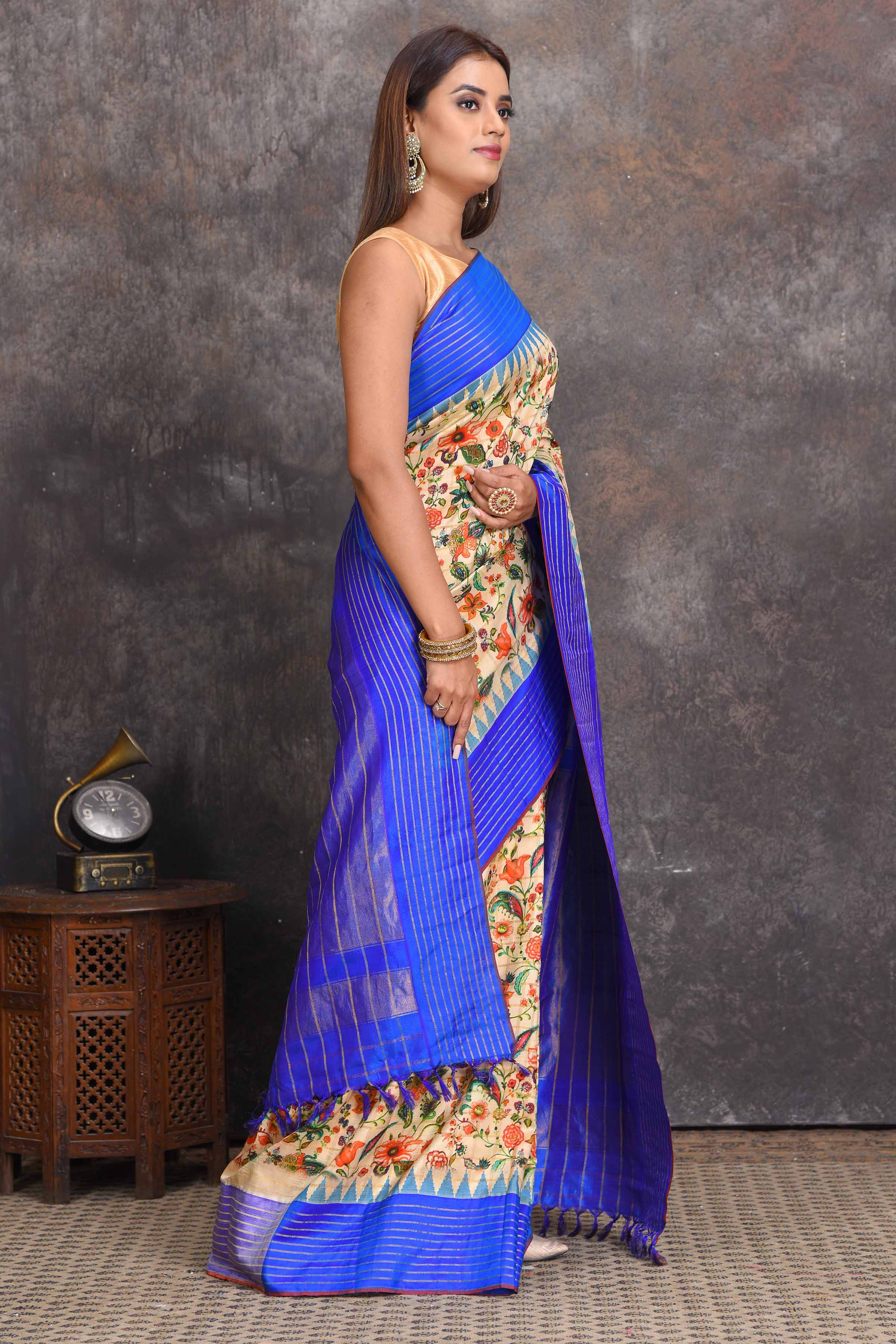 Shop cream printed Gadhwal silk saree online in USA with blue border. Get festive ready in beautiful Kanchipuram silk sarees, pure silk sarees, soft silk sarees, tussar silk saris, handwoven sarees, chanderi silk sarees from Pure Elegance Indian saree store in USA.-side