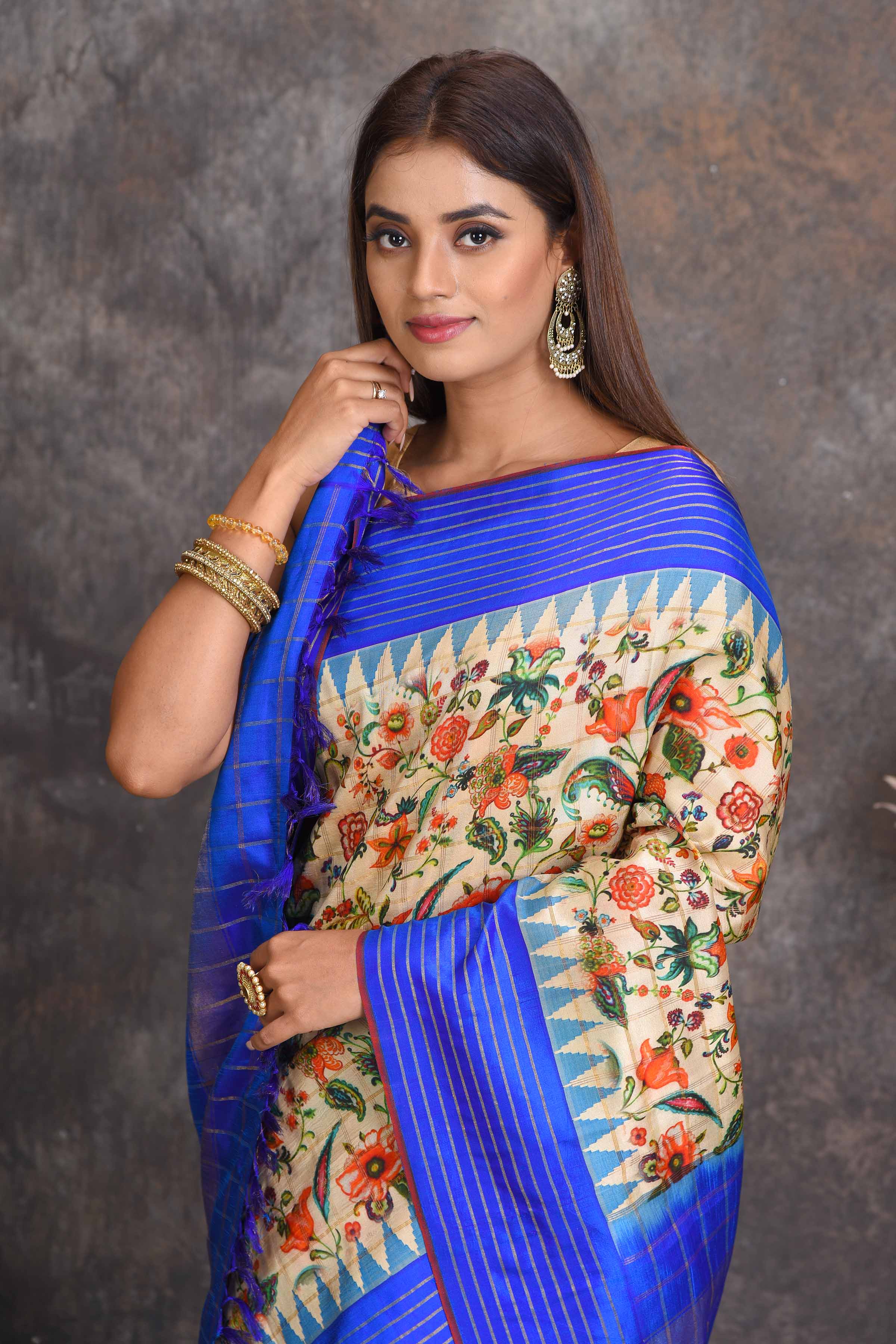 Shop cream printed Gadhwal silk saree online in USA with blue border. Get festive ready in beautiful Kanchipuram silk sarees, pure silk sarees, soft silk sarees, tussar silk saris, handwoven sarees, chanderi silk sarees from Pure Elegance Indian saree store in USA.-closeup