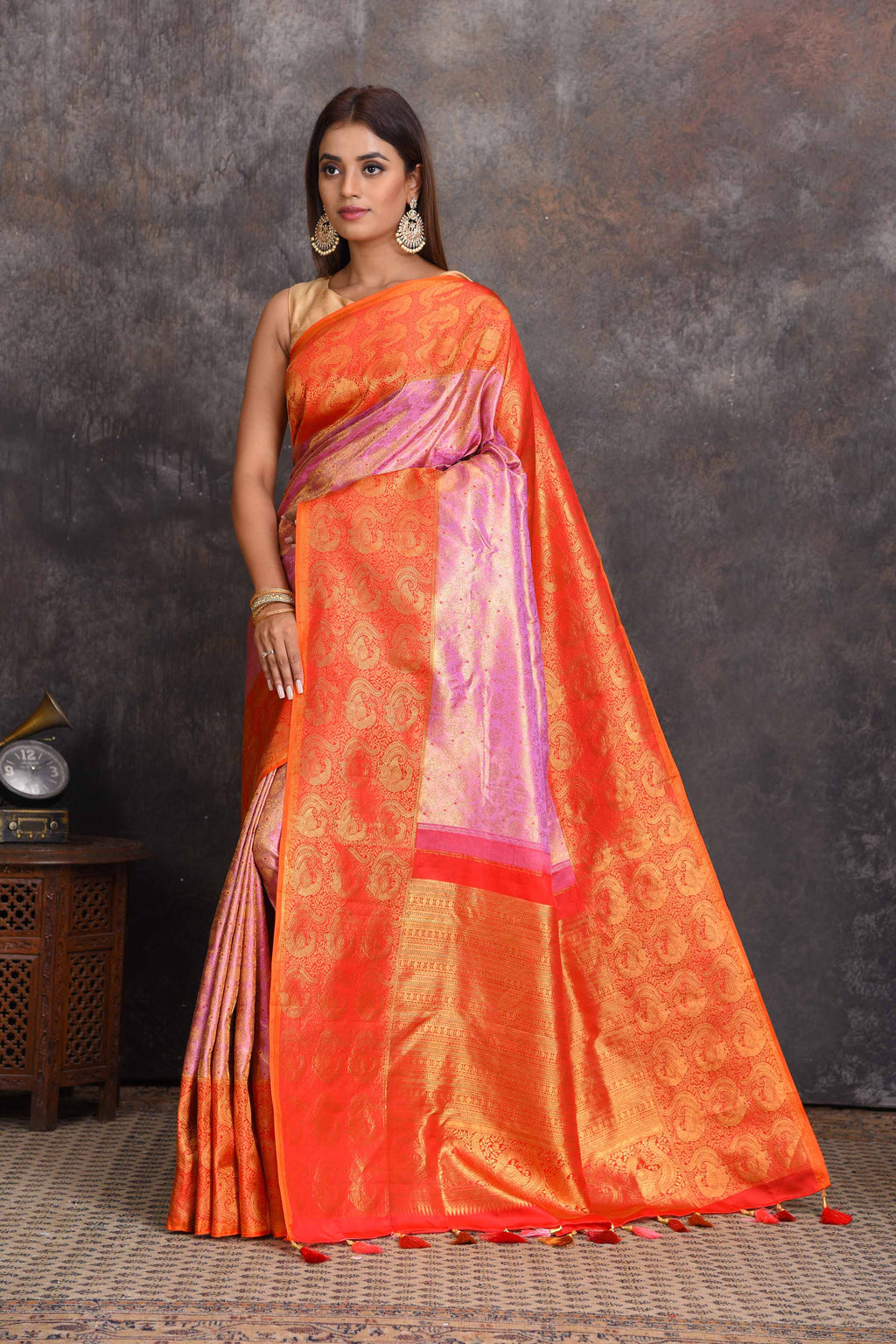 Buy beautiful lilac heavy Gadhwal silk saree online in USA with orange border. Get festive ready in beautiful Kanchipuram silk sarees, pure silk sarees, soft silk sarees, tussar silk saris, handwoven sarees, chanderi silk sarees from Pure Elegance Indian saree store in USA.-full view