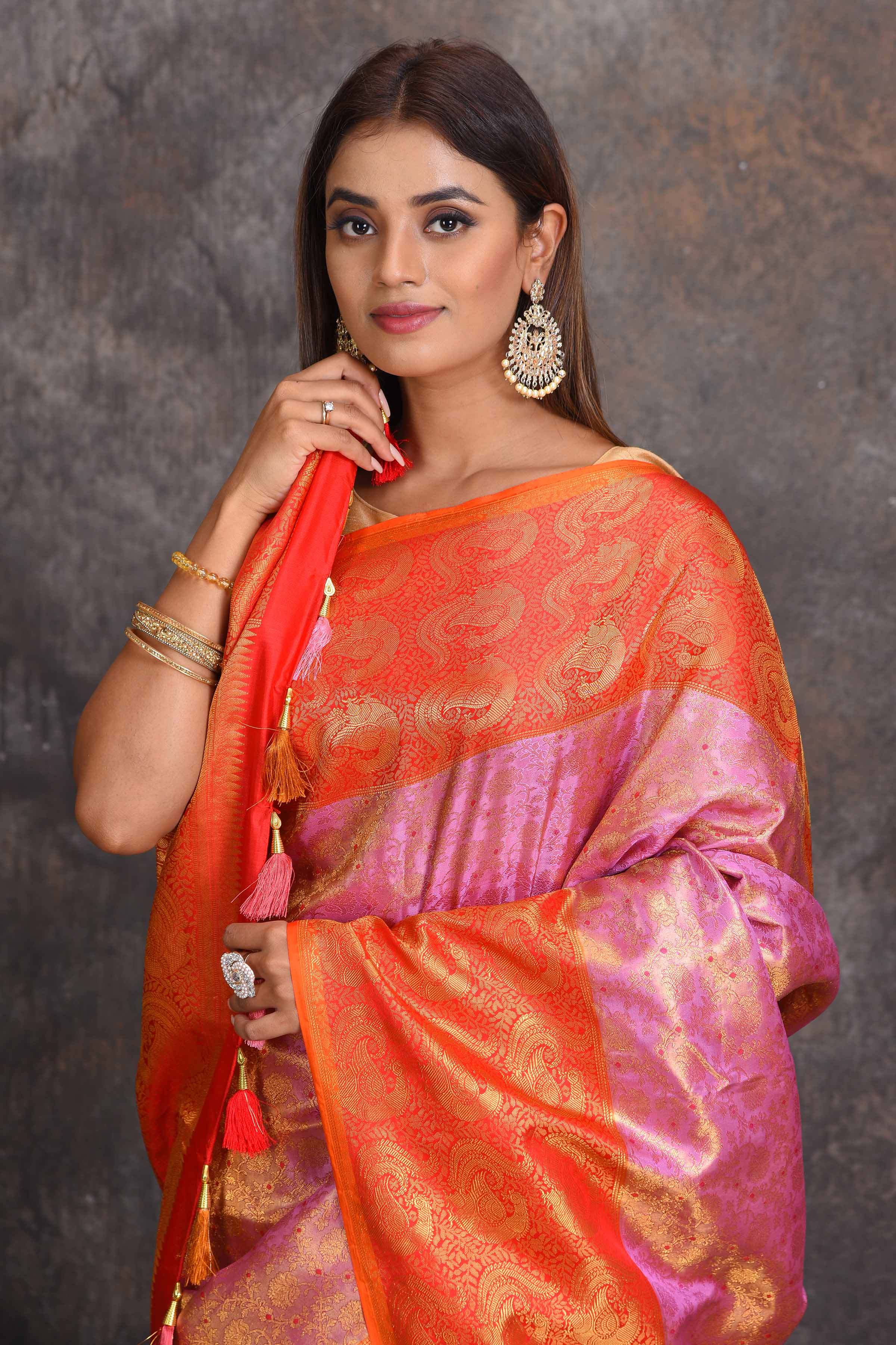 Buy beautiful lilac heavy Gadhwal silk saree online in USA with orange border. Get festive ready in beautiful Kanchipuram silk sarees, pure silk sarees, soft silk sarees, tussar silk saris, handwoven sarees, chanderi silk sarees from Pure Elegance Indian saree store in USA-closeup