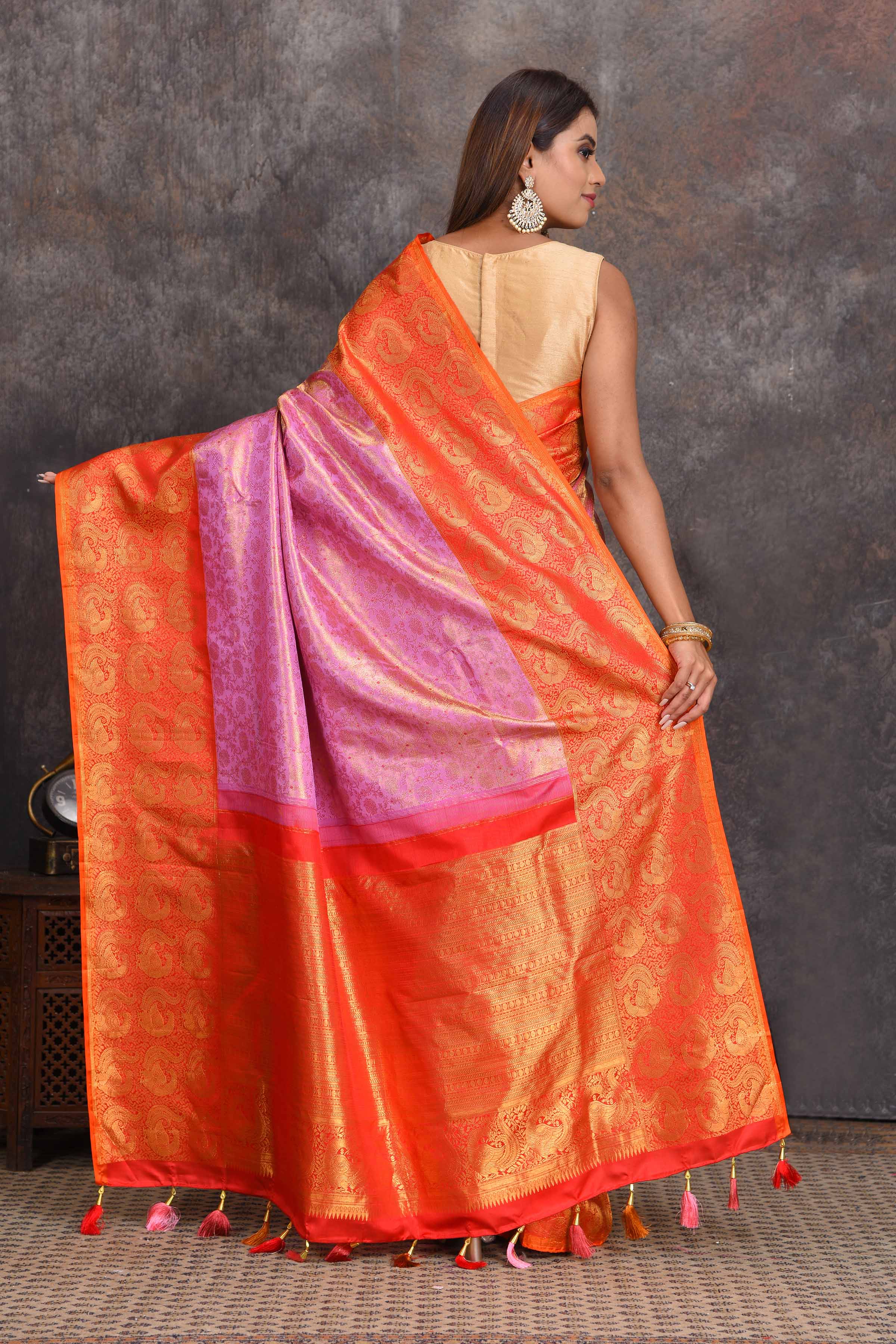 Buy beautiful lilac heavy Gadhwal silk saree online in USA with orange border. Get festive ready in beautiful Kanchipuram silk sarees, pure silk sarees, soft silk sarees, tussar silk saris, handwoven sarees, chanderi silk sarees from Pure Elegance Indian saree store in USA.-back
