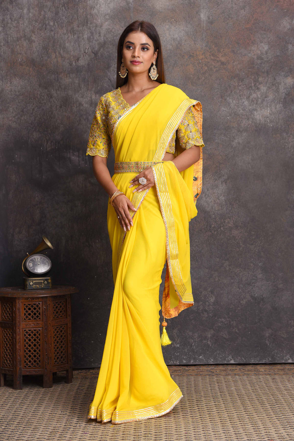 Buy beautiful yellow georgette saree online in USA with embroidered belt and blouse. Set a style statement on special occasions in exquisite designer sarees, handwoven sarees, georgette sarees, embroidered sarees, Banarasi saree, pure silk saris, tussar sarees from Pure Elegance Indian saree store in USA.-full view