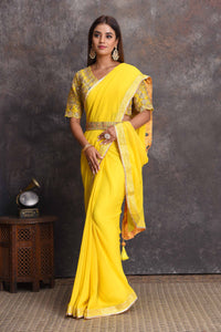 Buy beautiful yellow georgette saree online in USA with embroidered belt and blouse. Set a style statement on special occasions in exquisite designer sarees, handwoven sarees, georgette sarees, embroidered sarees, Banarasi saree, pure silk saris, tussar sarees from Pure Elegance Indian saree store in USA.-full view