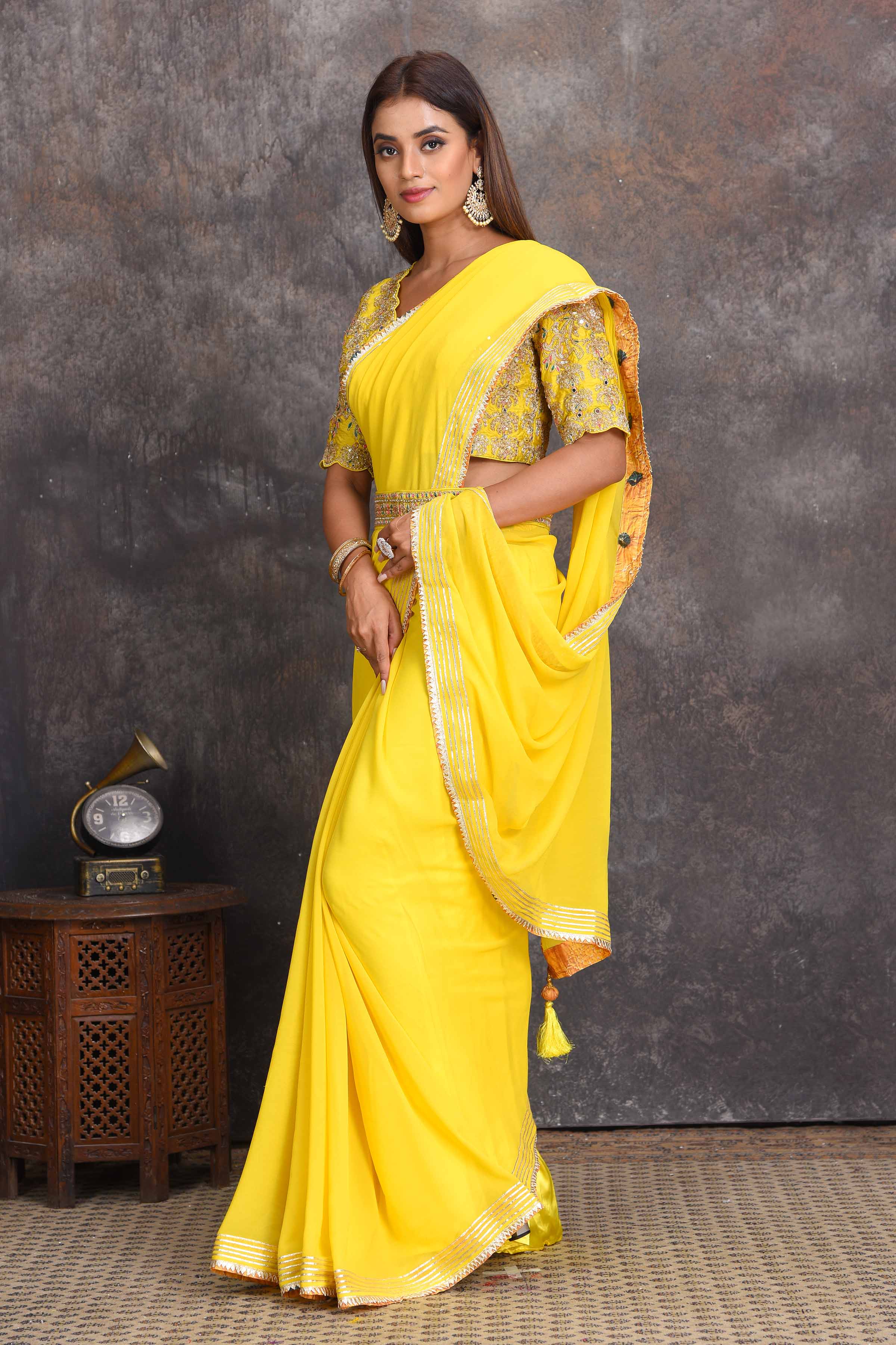Buy beautiful yellow georgette saree online in USA with embroidered belt and blouse. Set a style statement on special occasions in exquisite designer sarees, handwoven sarees, georgette sarees, embroidered sarees, Banarasi saree, pure silk saris, tussar sarees from Pure Elegance Indian saree store in USA.-side