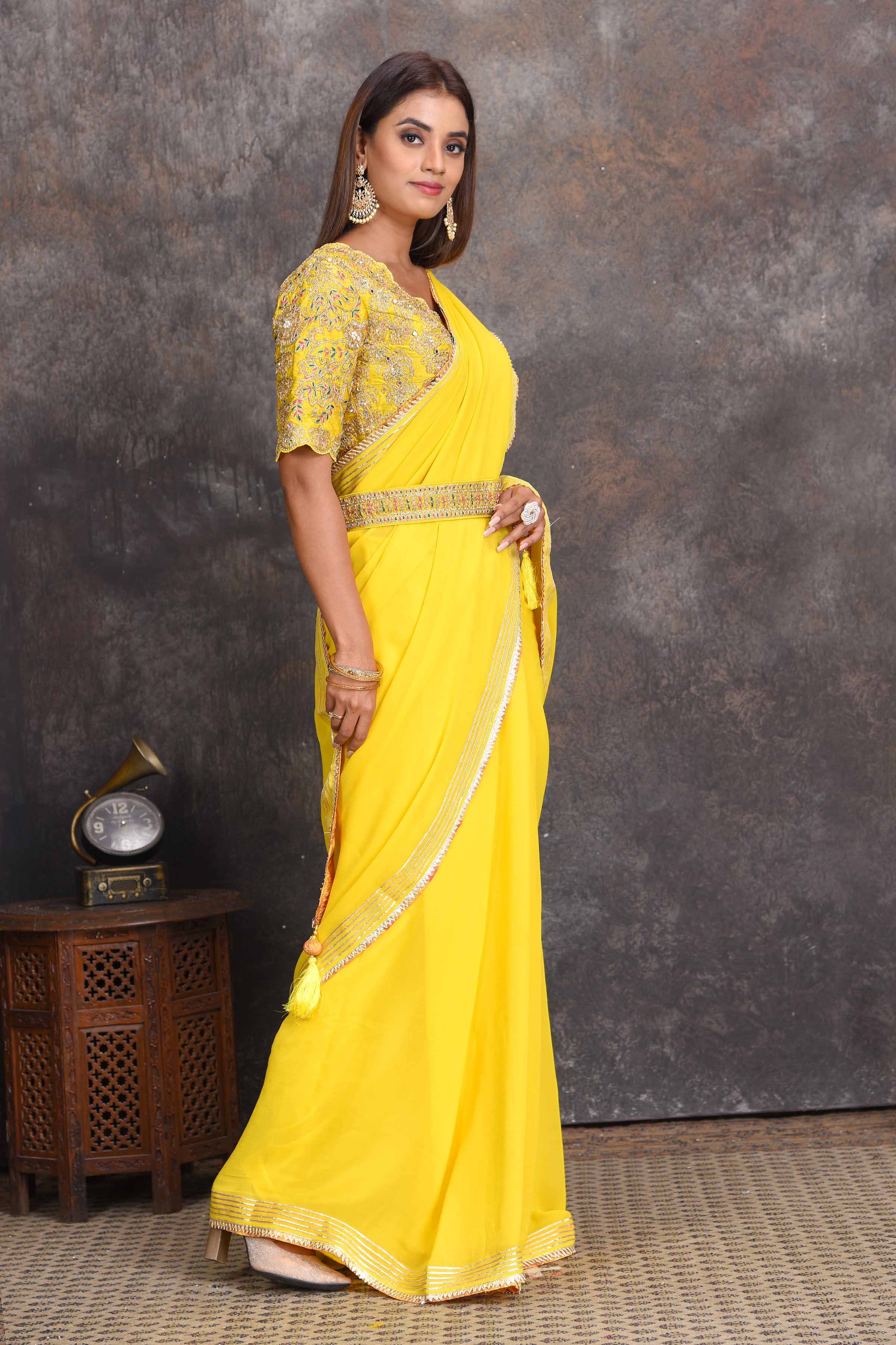 Buy beautiful yellow georgette saree online in USA with embroidered belt and blouse. Set a style statement on special occasions in exquisite designer sarees, handwoven sarees, georgette sarees, embroidered sarees, Banarasi saree, pure silk saris, tussar sarees from Pure Elegance Indian saree store in USA.-right